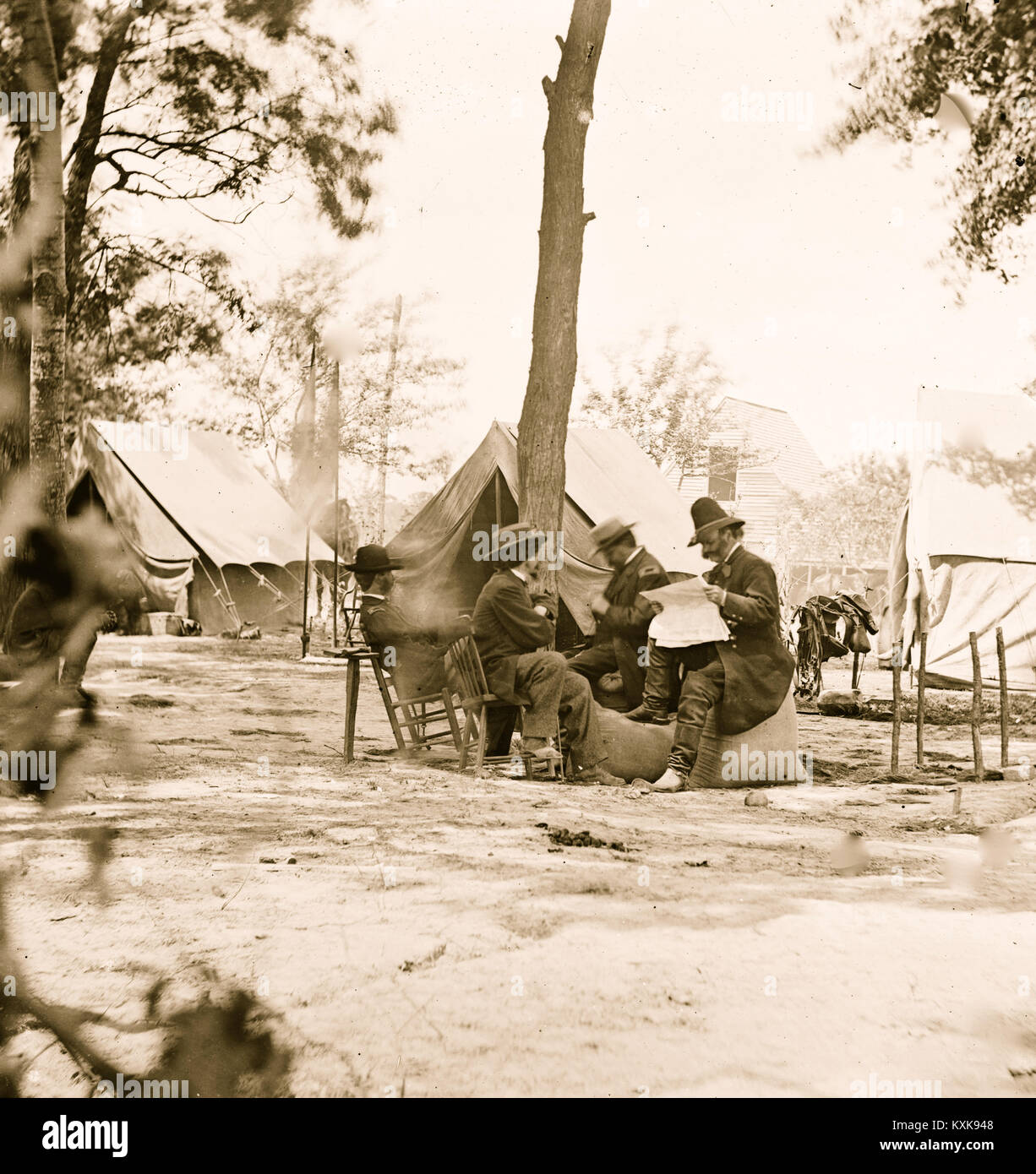 Gen. Ambrose E. Burnside (reading newspaper) with Mathew B. Brady (nearest tree) at Army of the Potomac headquarters Stock Photo