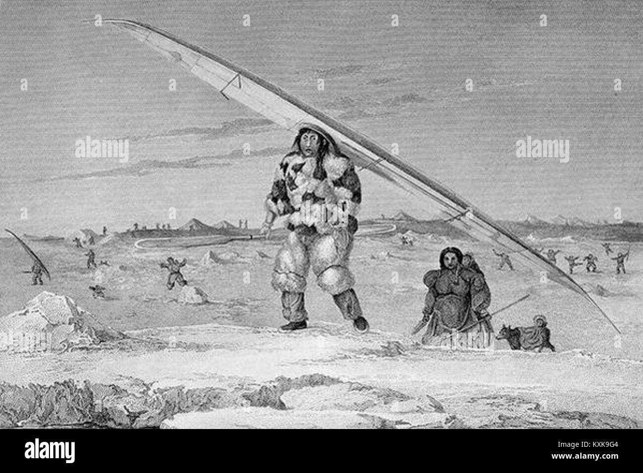 An eskimaux of igloolik wearing a bird-skin jacket, carrying his canoe down the water Stock Photo