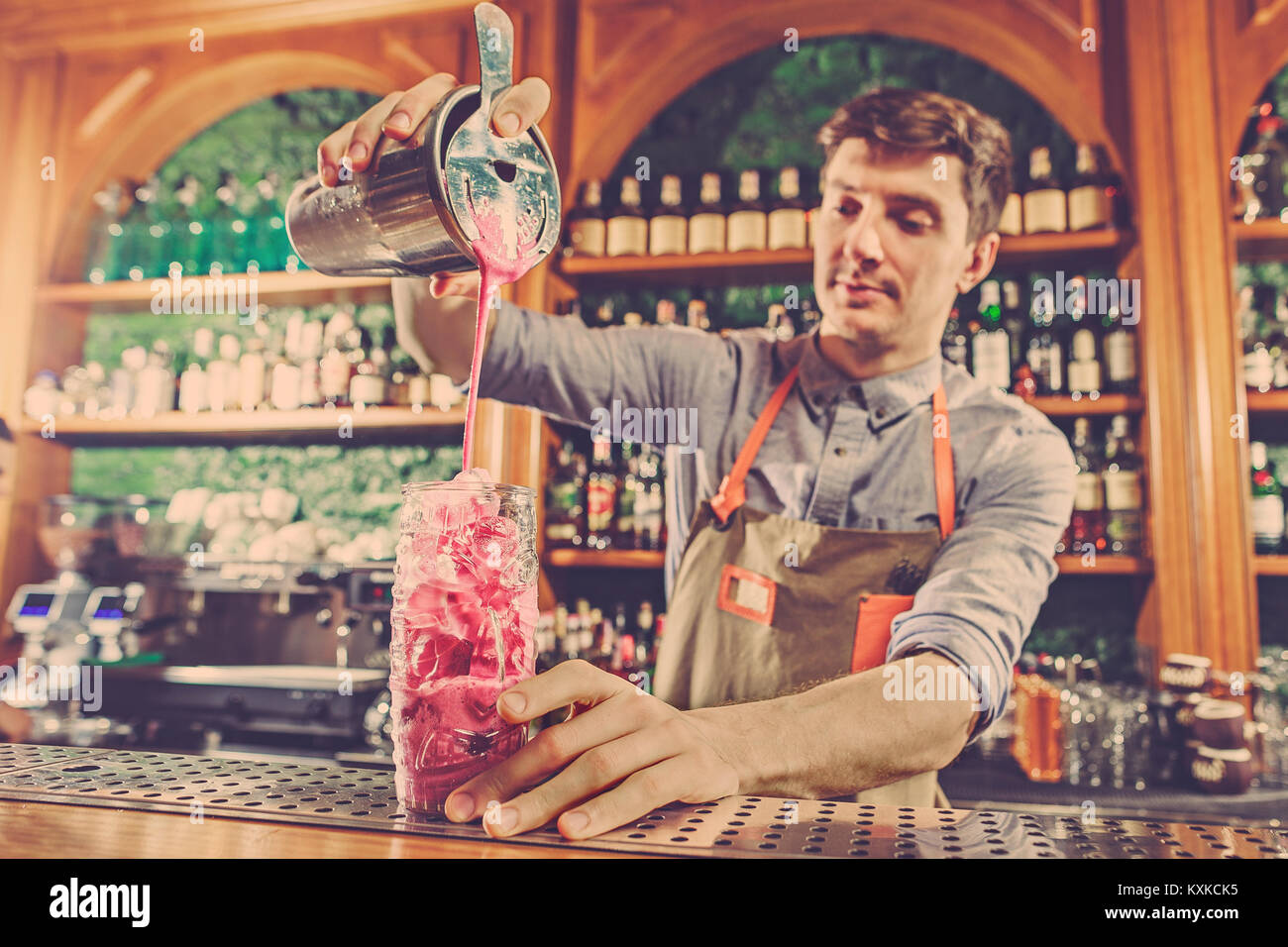 Expert barman is making cocktail with shaker at night club. Copy space  Stock Photo - Alamy