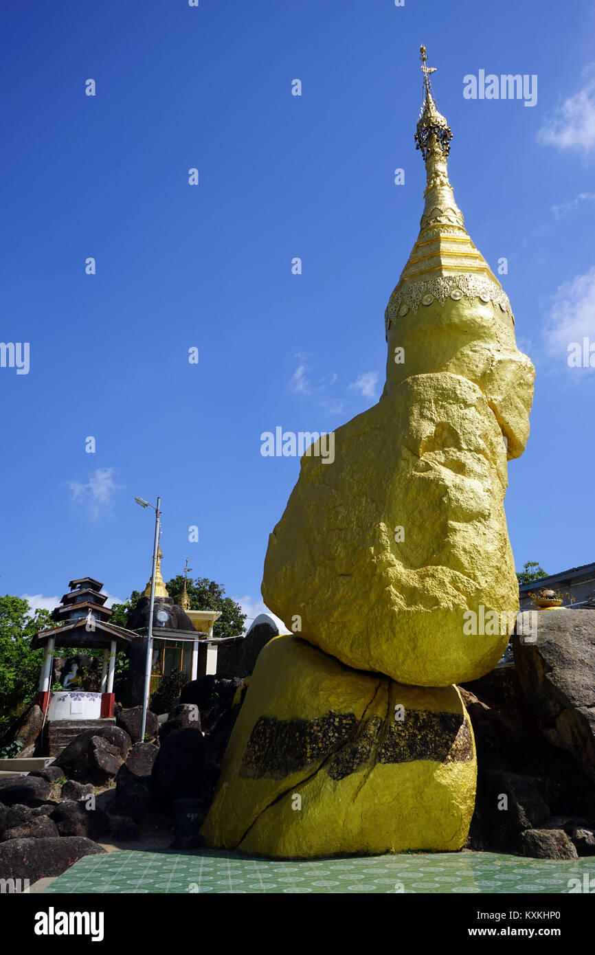 MAWLAMYINE, MYANMAR - CIRCA APRIL 2017 Golden rock in Nwa-la-bo pagoda Stock Photo