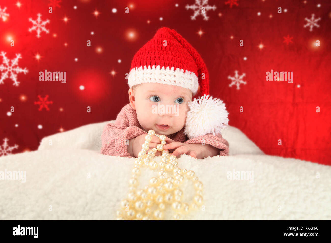 Pretty baby girl in Christmas Hat, festive fun, merry Christmas, child development Stock Photo