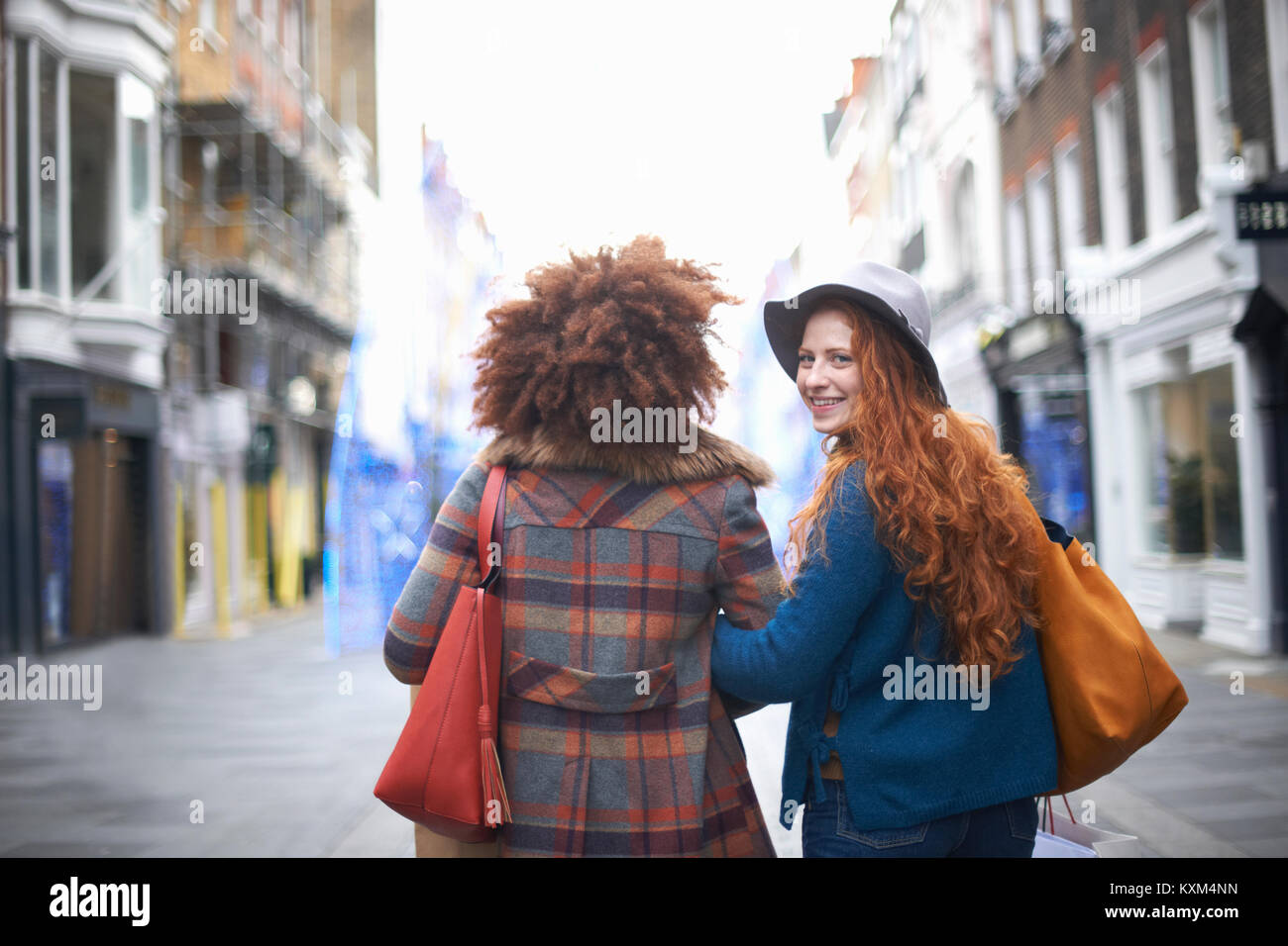 Two young women walking arm hi-res stock photography and images - Alamy