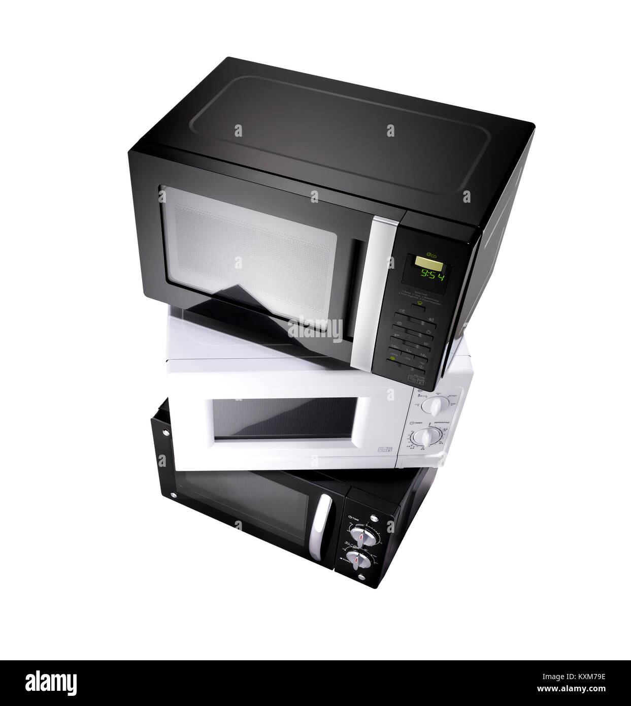 A stack of three microwaves shot with a wide angle lens on a white background Stock Photo