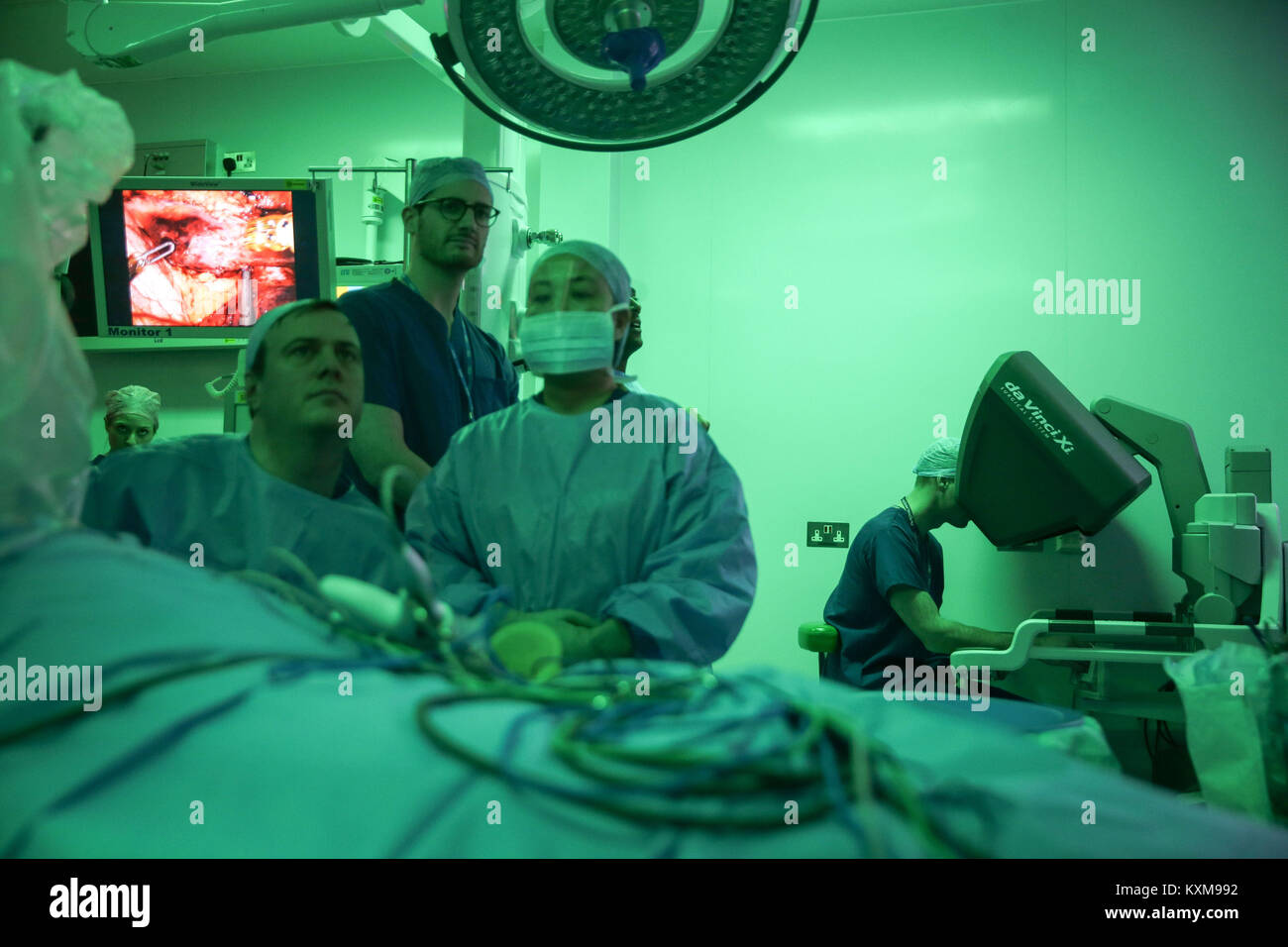 The Duke of Cambridge (right) looks through a dual console of the da Vinci robot as he observes a highly complex robotic cancer operation to remove a tumour of the oesophagus at the junction between the heart, lungs and aorta of patient Charles Ludlow, 63, during his visit to the Royal Marsden NHS Foundation Trust in London. Stock Photo