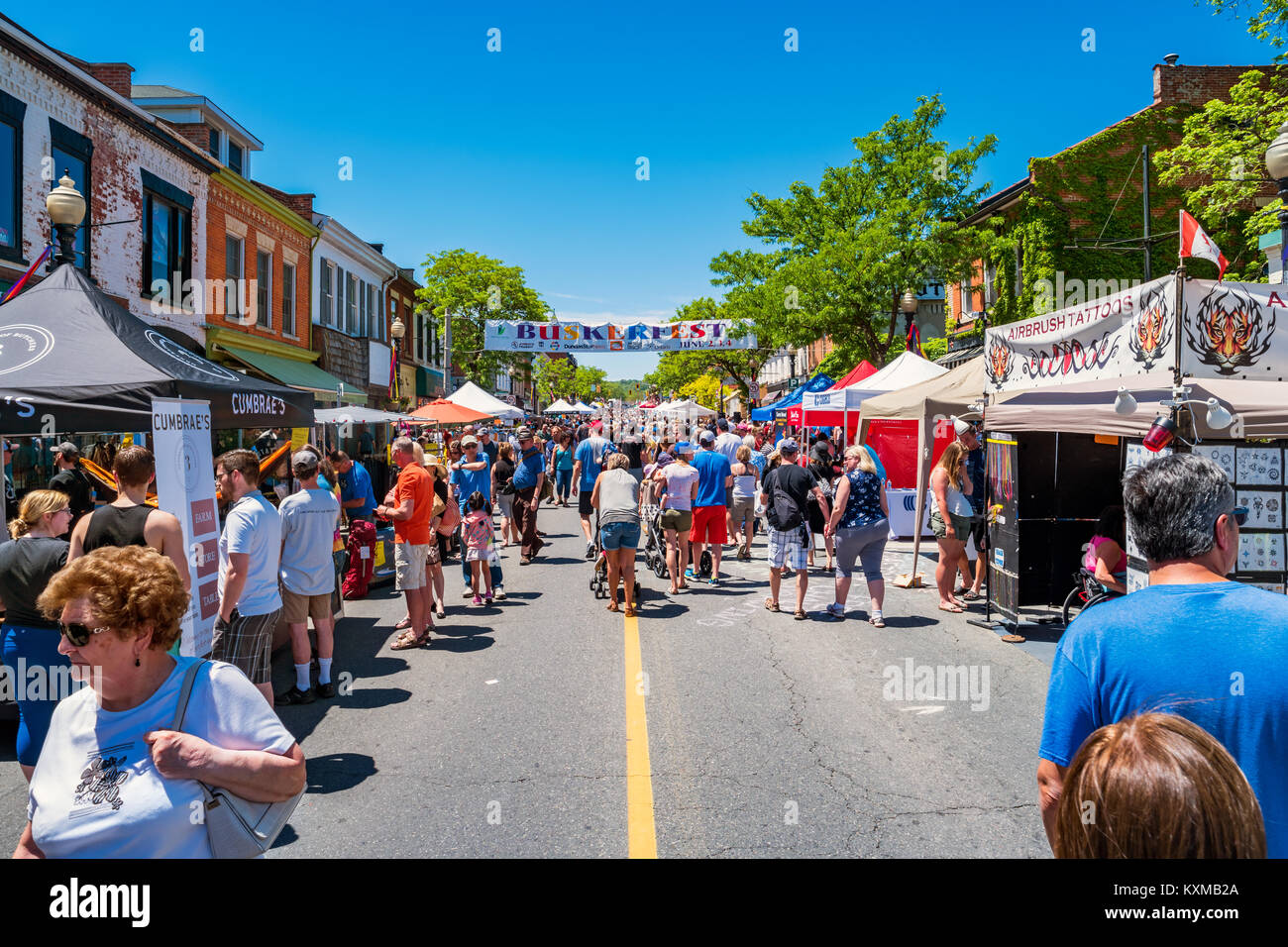 Crowd enjoys a sunny day at the Buskerfest held along King St W in downtown Dundas, Ontario, Canada on a sunny day. Stock Photo