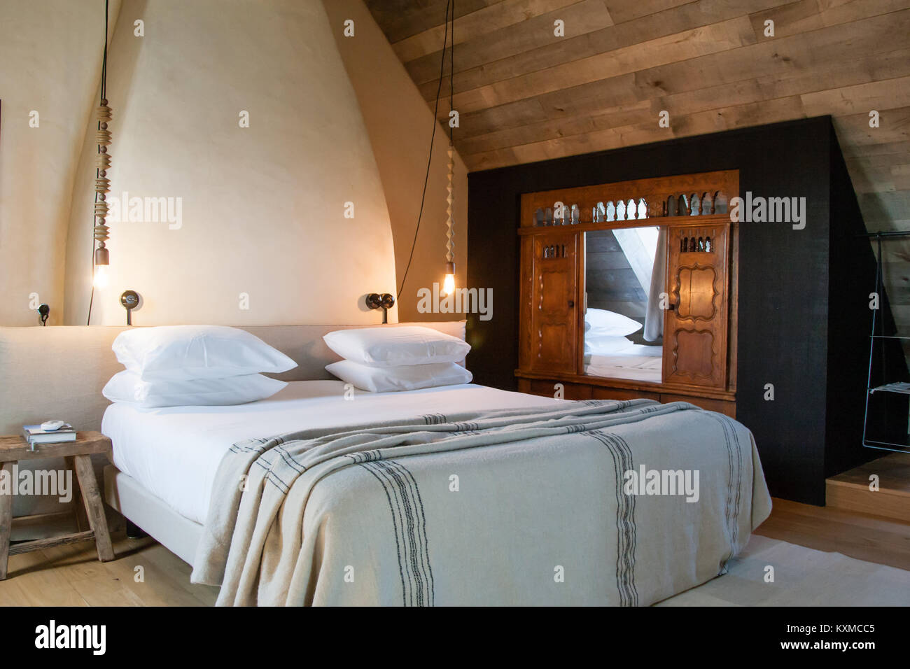 An antique Breton fold-away bed has been built into this bedroom as a child's cot, in the 'La Fenouillette' cottage of La Ferme du Vent near Château de Richeux, Saint-Méloir-des-Ondes near Saint-Malo, Brittany, France. Stock Photo