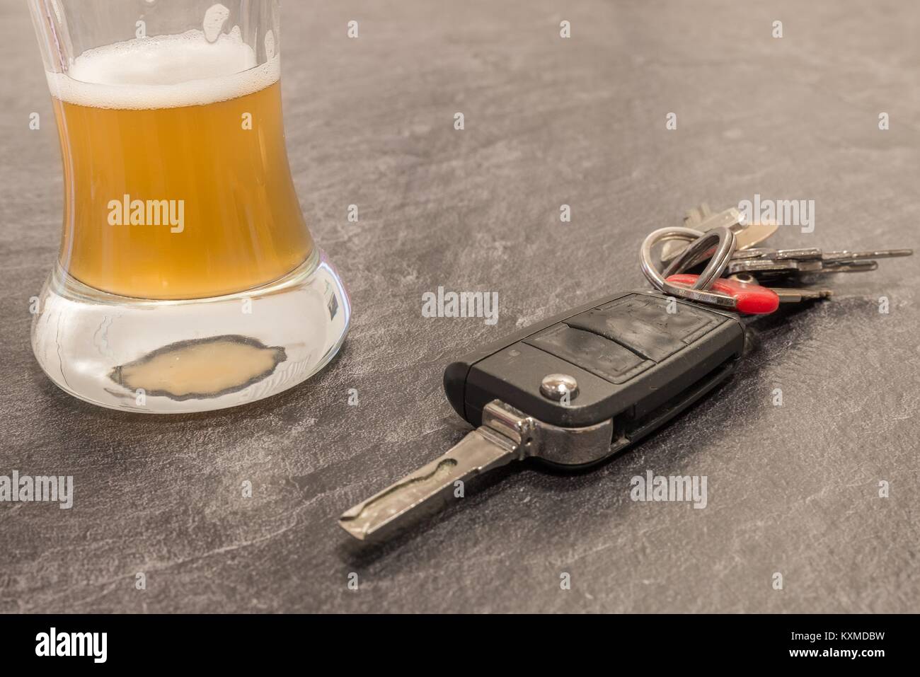 Glass of Beer and car key on grey table Stock Photo Alamy