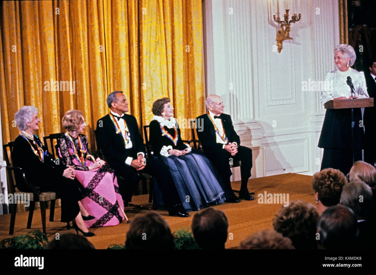 First lady Barbara Bush makes remarks during a ceremony for 1989 Kennedy Center Honorees in the East Room of the White House, December 3, 1989 in Washington, DC. The 1989 honorees are, from left to right: actress and singer Mary Martin, dancer Alexandra Danilova, singer and actor Harry Belafonte, actress Claudette Colbert, and composer William Schuman. Credit: Peter Heimsath / Pool via CNP /MediaPunch Stock Photo