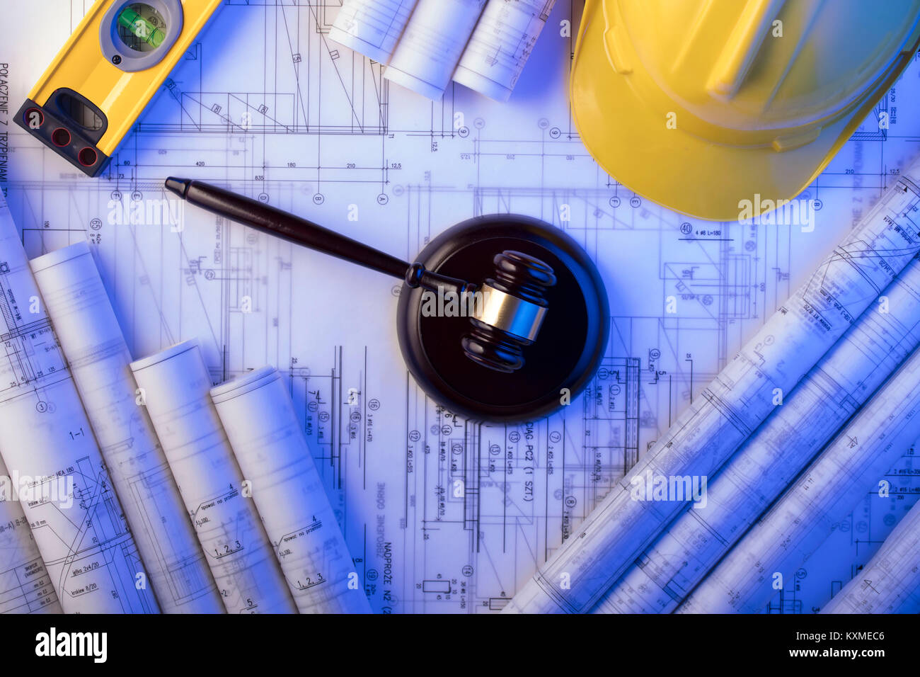 Labor and construction law. Gavel, helmet and blueprints Stock Photo
