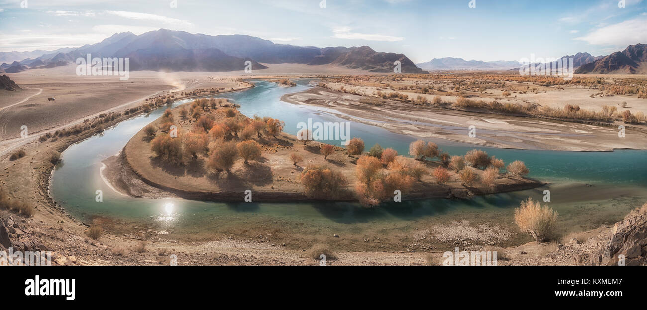 Green river bank yellow leafs fall golden hour calm stream Mongolia panorama Stock Photo