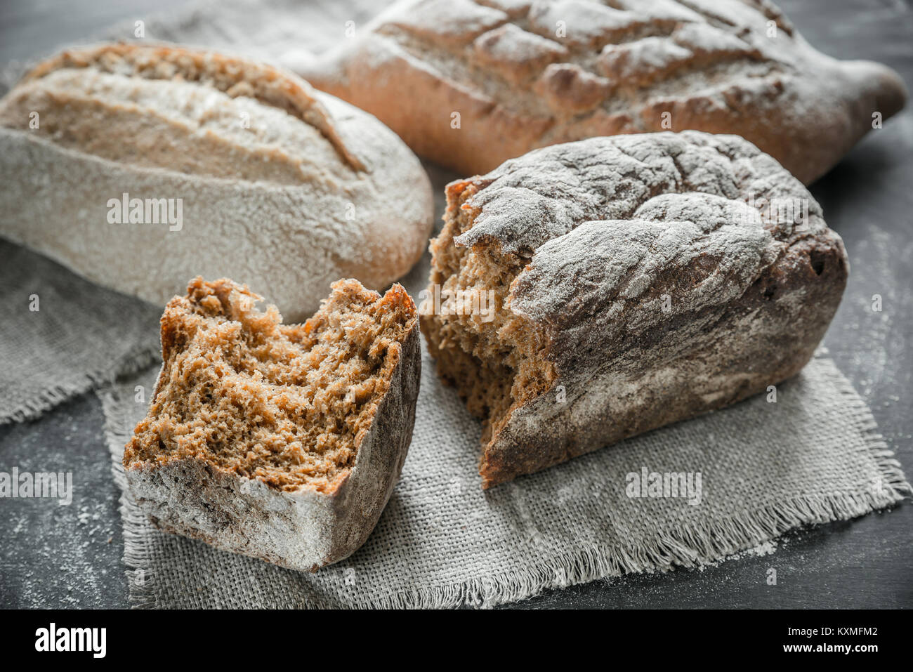 Whole grain breads on the dark wooden background Stock Photo - Alamy