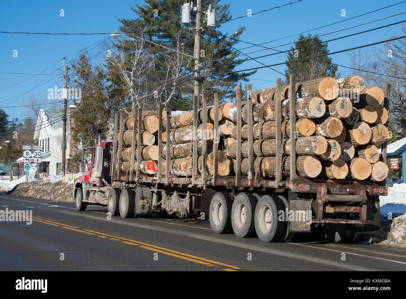 A tractor trailer load of logs parked on the road in Speculator, New York on it's way to a saw mill. Stock Photo