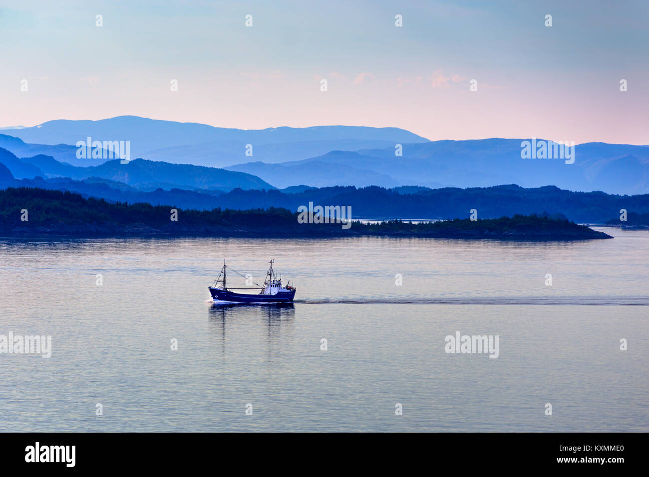 Fishing boat at dawn in the still coastal waters south of Bergen, Hordaland, Norway. Stock Photo