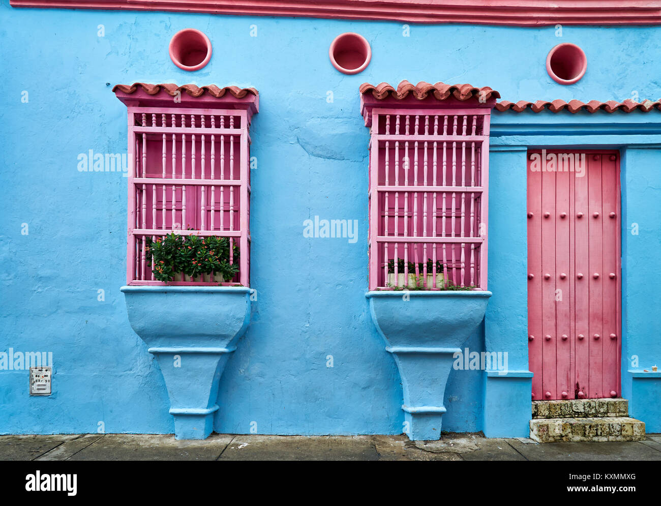 blue facade with pink barred windows of houses in Cartagena de Indias,  Colombia, South America Stock Photo - Alamy
