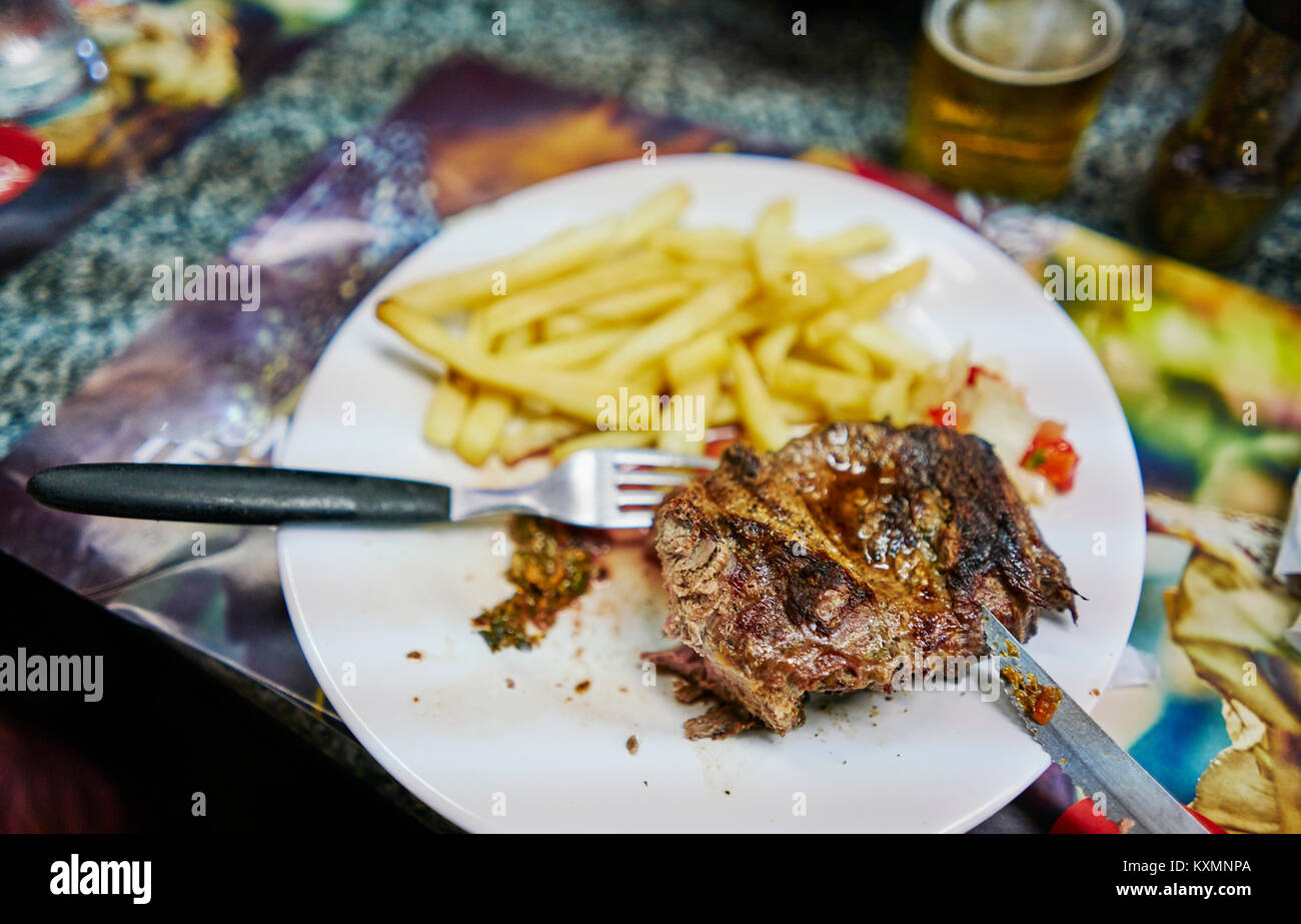 Steak and fries on plate Stock Photo