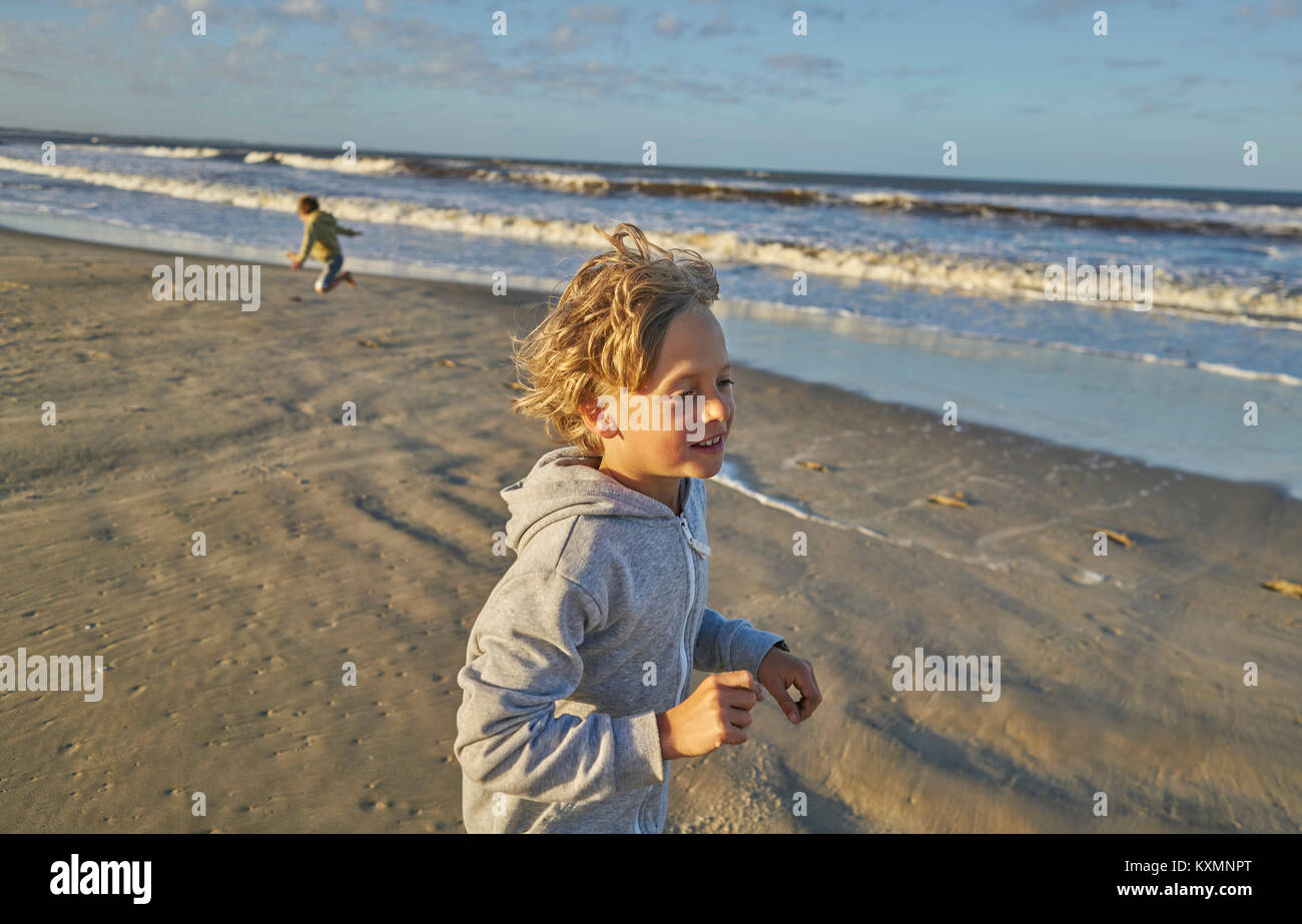 Boy in beach playing in lapping waves,Polonio,Rocha,Uruguay,South America Stock Photo