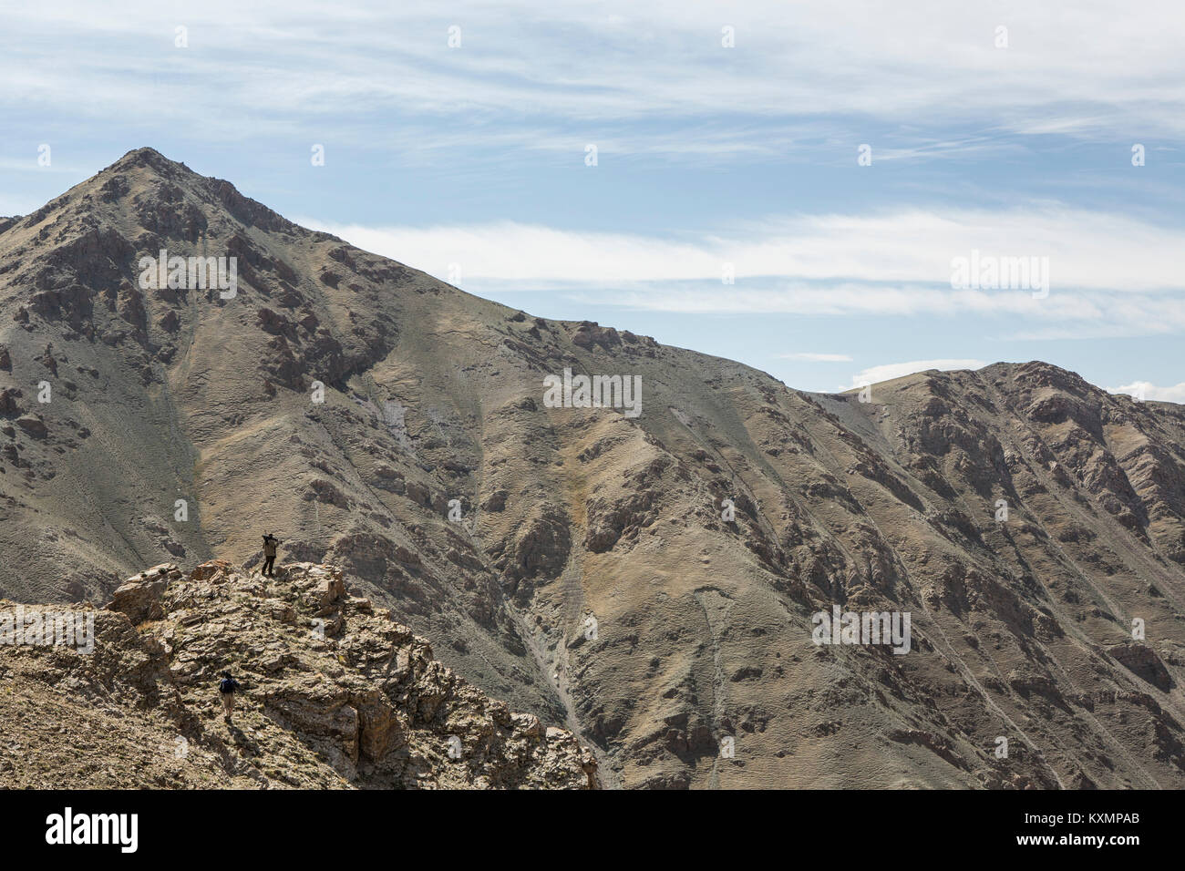 Distant view of climber on top rugged mountain,Altai Mountains,Khovd,Mongolia Stock Photo