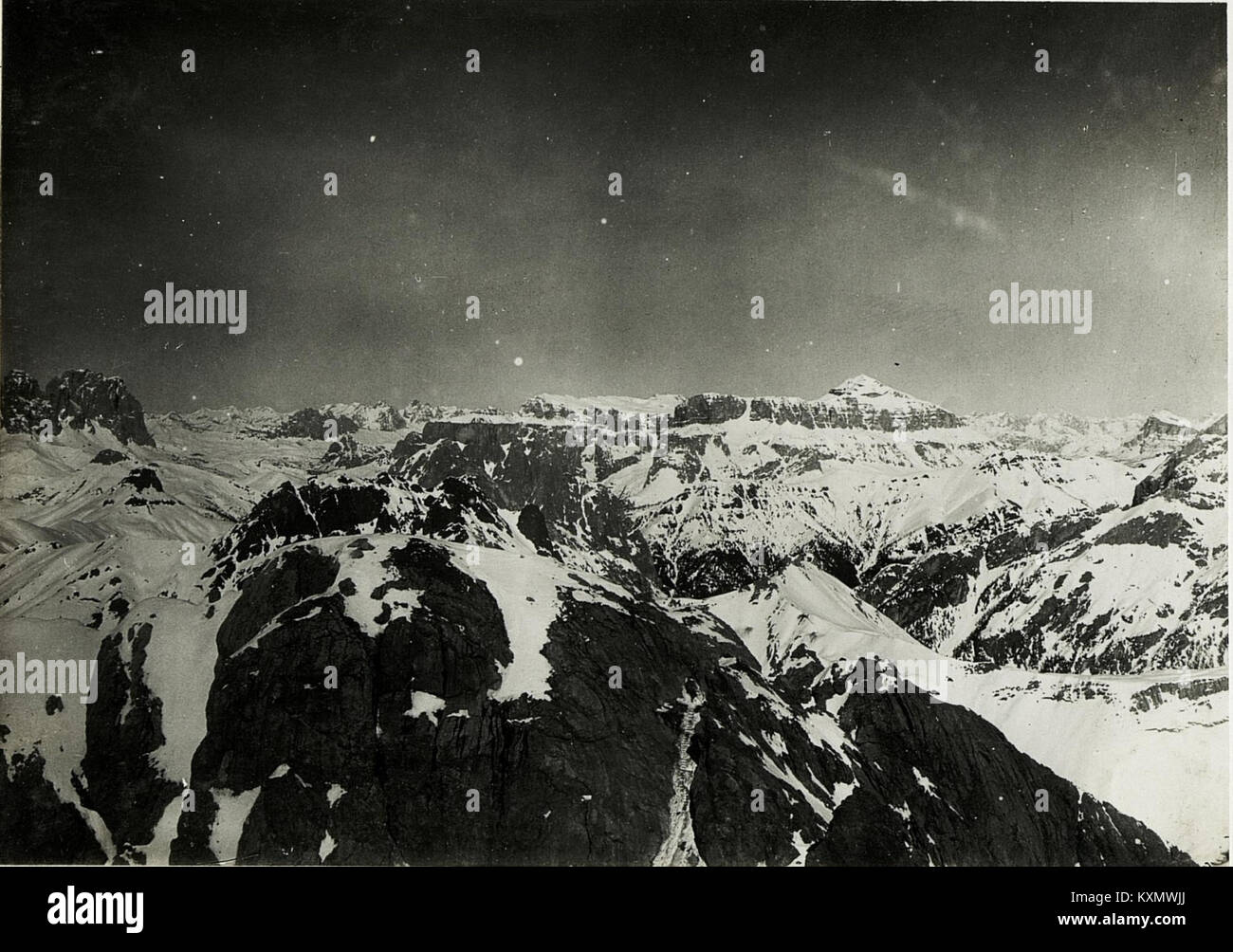 This photograph captures the view from Cima di Costabella in the Sella Group, Italy, looking northeast over Col Ombert and Contrintal towards the Cadin Walls and the Marmolada massif, including Gran Vernel peak. Stock Photo