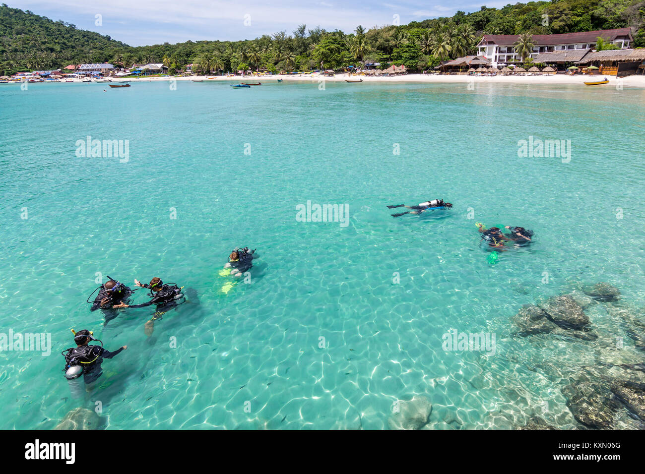 A group of Scuba Diving students have a lesson in the shallow crystal clear water of a Tropical Island. Stock Photo