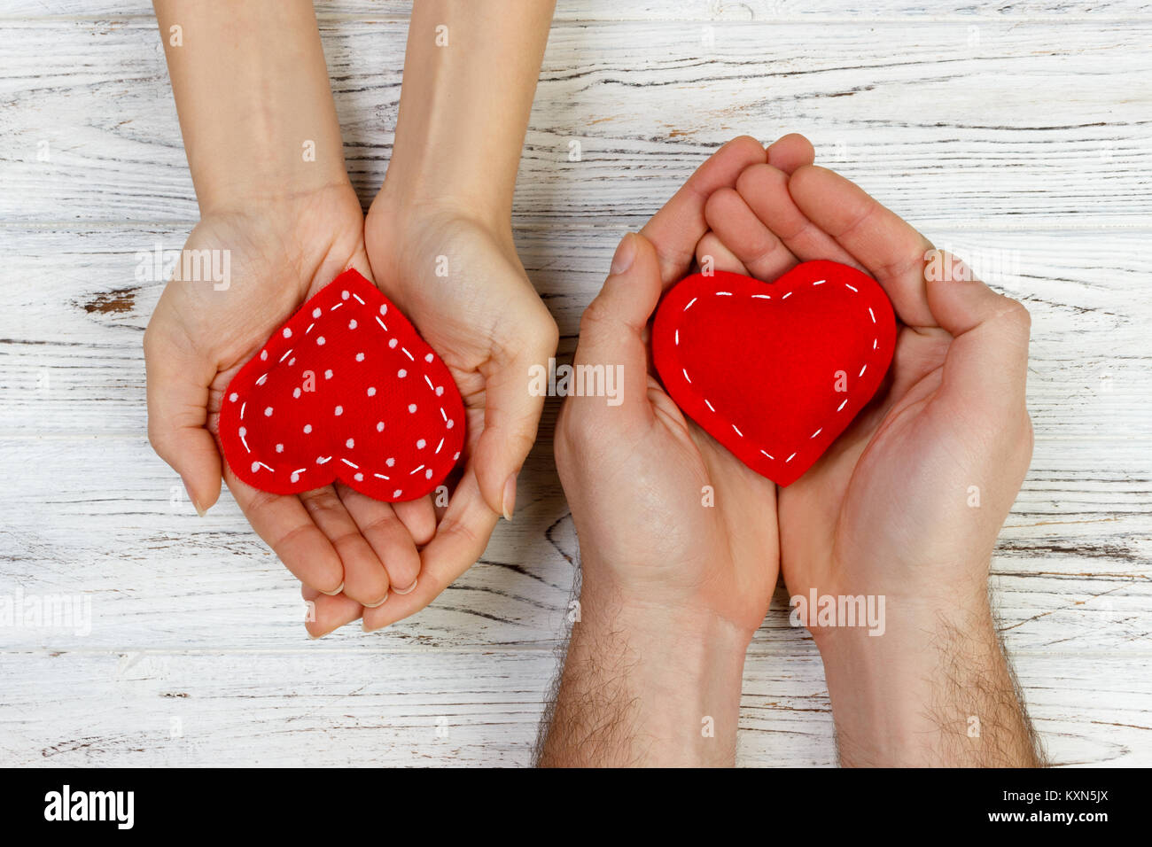 Couple in love holding a red heart in their hands. Valentine day ...
