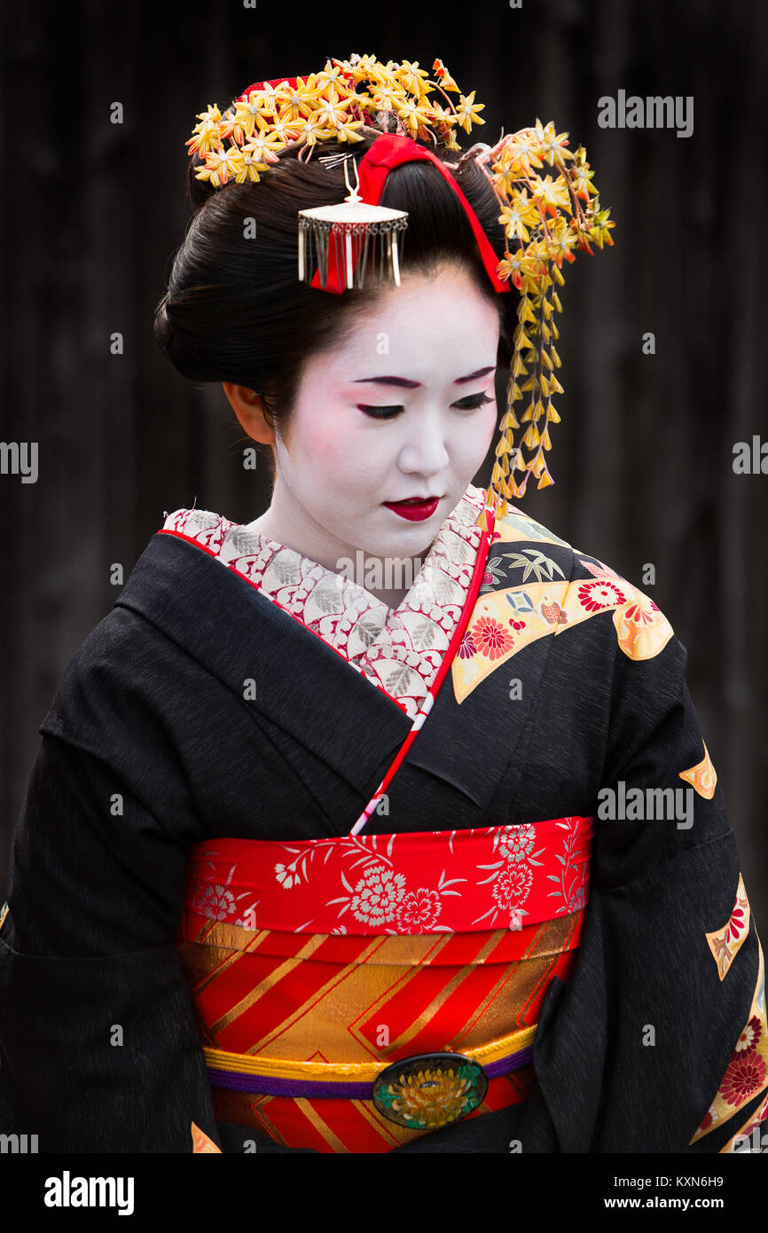 A geisha walks through the streets of Kyoto, Japan. Stock Photo