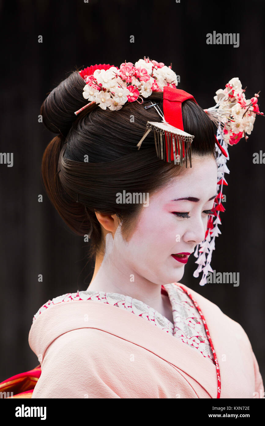 A geisha walks through the streets of Kyoto, Japan. Stock Photo