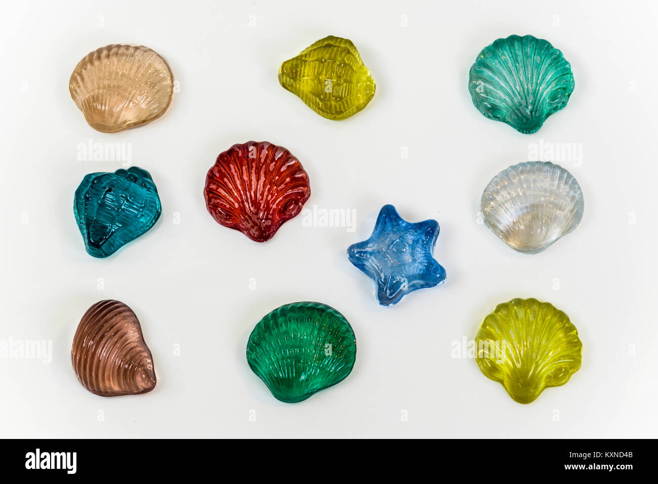 Colorful seashell ornaments made of glass isolated on white background