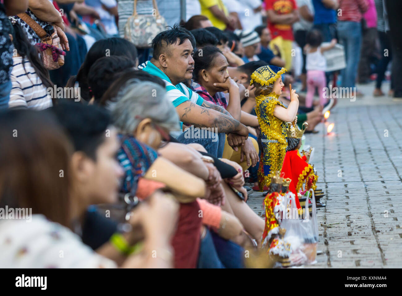 Cebu City, Philippines . 10th Jan, 2018. After an early morning candelelight procession attended by thousands of Catholics in Cebu City,Filipinos gather around the Basilica Minore del Santo Nino participating in prayer and singing of the hymn Bato Balani.Many will have brought with them Santo Nino figurines which represents their belief in the Child Jesus,Santo Nino de Cebu. Credit: imagegallery2/Alamy Live News Stock Photo