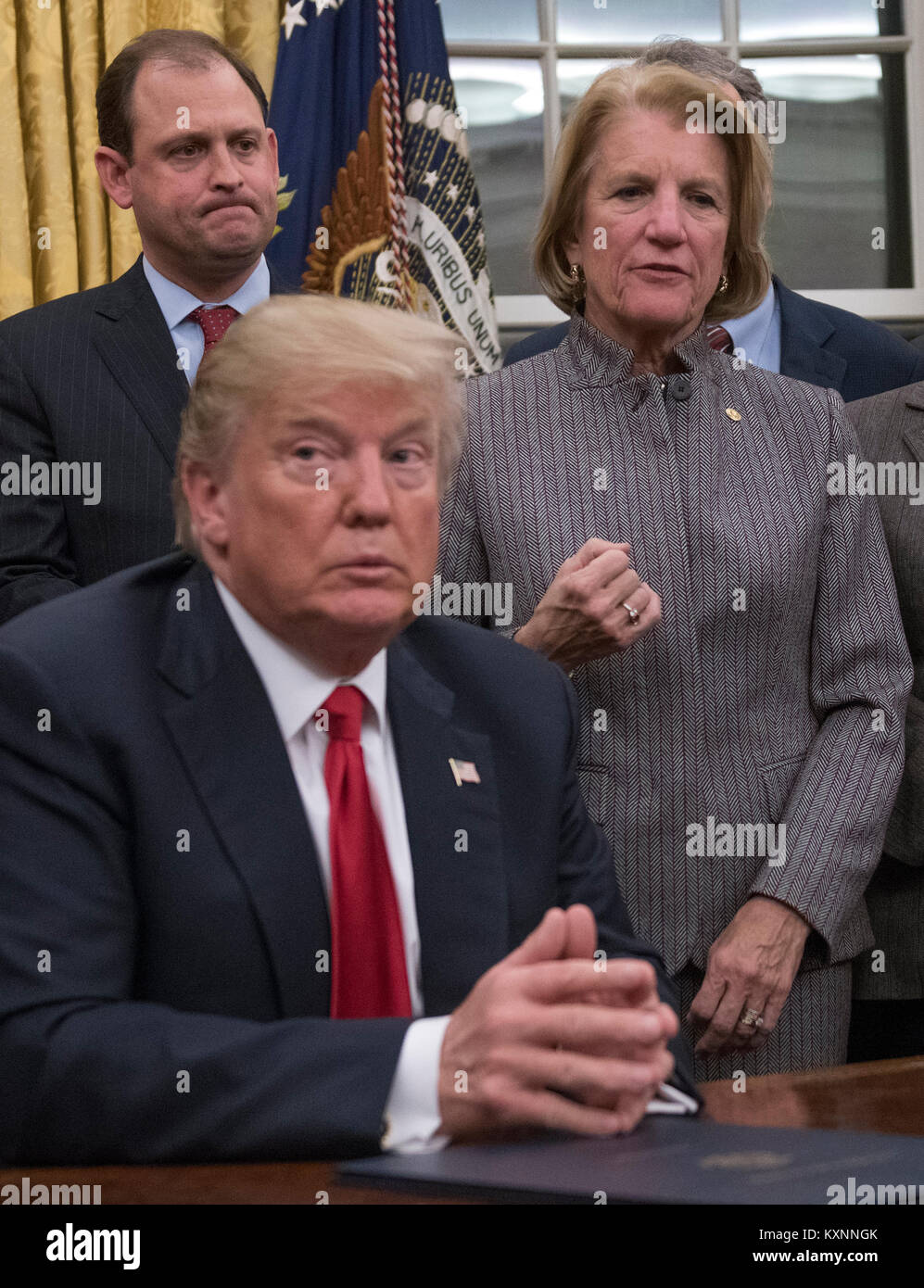 United States President Donald J. Trump listens as US Senator Shelley Moore Capito (Republican of West Virginia) makes remarks prior to his signing the bipartisan Interdict Act, a bill to stop the flow of opioids into the United States in the Oval Office of the White House in Washington, DC on Wednesday, January 10, 2018. The Interdict Act will provide Customs and Border Protection agents with the latest screening technology devices used to secure our border from illicit materials, specifically fentanyl, a powerful opioid that is destroying lives across the country. Credit: Ron Sachs / Pool vi Stock Photo