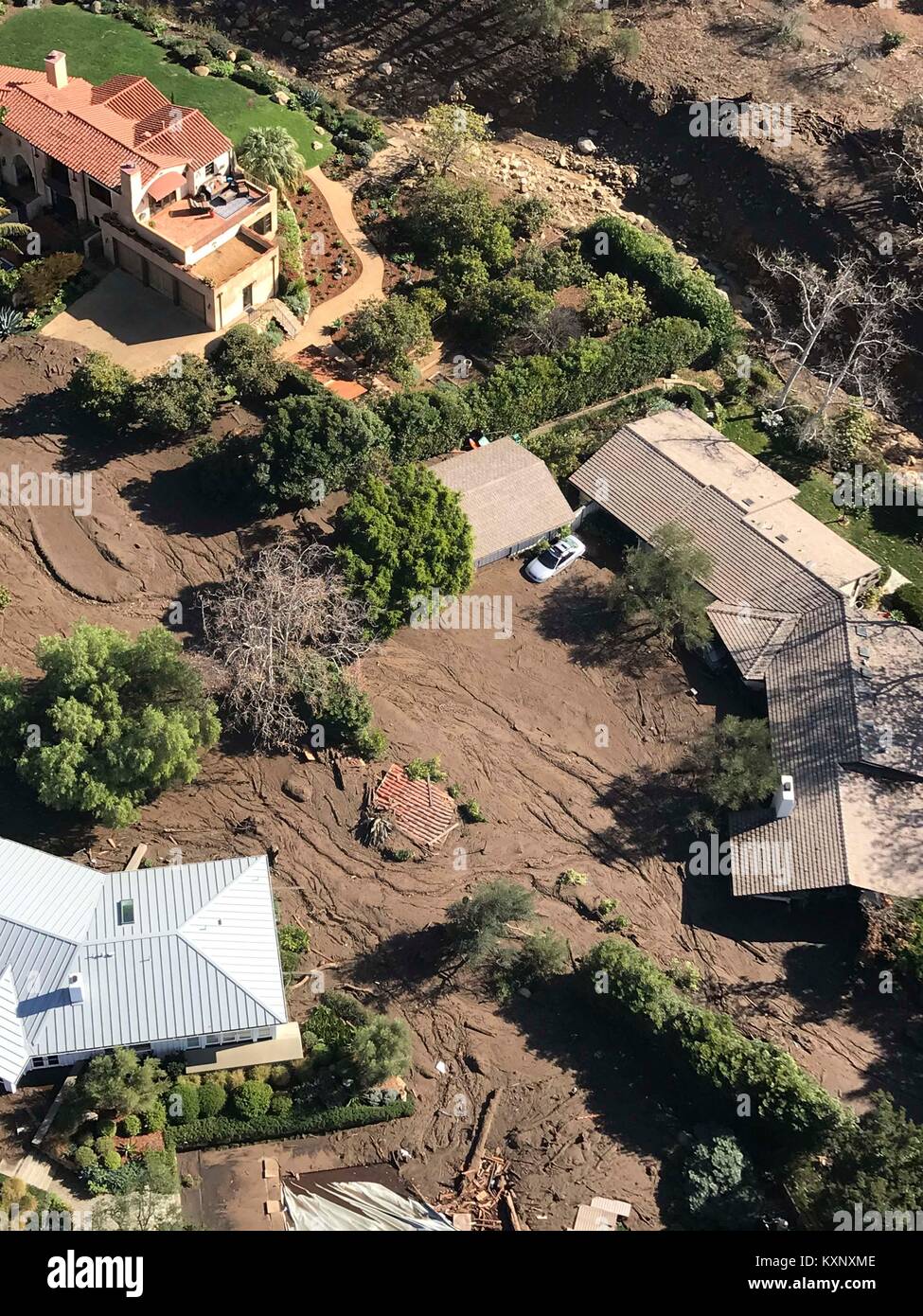 Montecito, United States. 10th Jan, 2018. A U.S. National Guard helicopter performs an aerial search for survivors in homes destroyed by massive mudslides after record rains fell across a region scorched by wildfires in Santa Barbara county January 10, 2018 in Montecito, California. Credit: Planetpix/Alamy Live News Stock Photo