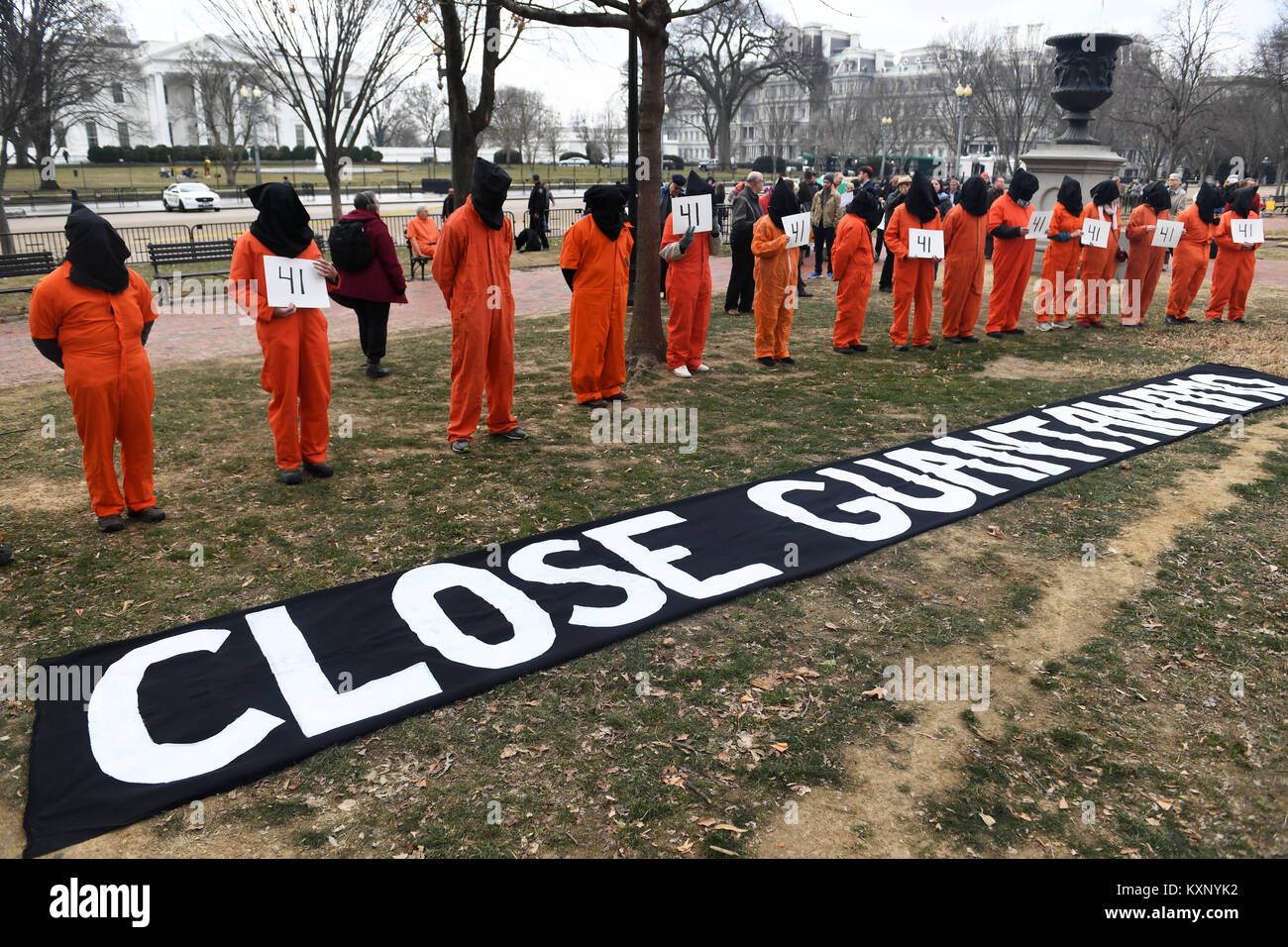 Washington, USA. 11th Jan, 2018. Protesters dressed as detainees of the Guantanamo Bay detention camp rally to demand the closing of the Guantanamo Bay detention camp outside the White House in Washington, DC, the United States, on Jan. 11, 2018. Dozens of Activists held a rally here on Thursday to protest against the Guantanamo Bay detention camp while urging an end to 'indefinite detention.' Credit: Yin Bogu/Xinhua/Alamy Live News Stock Photo