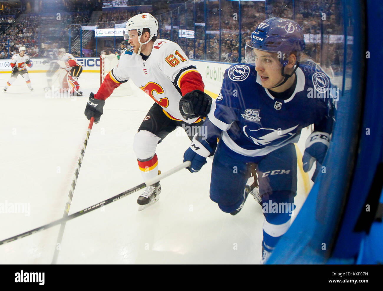 Tampa, Florida, USA. 11th Jan, 2018. DIRK SHADD | Times .Tampa Bay Lightning center Yanni Gourde (37) battle along the boards against Calgary Flames defenseman Brett Kulak (61) during first period action at Amalie Arena in Tampa (01/11/18) Credit: Dirk Shadd/Tampa Bay Times/ZUMA Wire/Alamy Live News Stock Photo