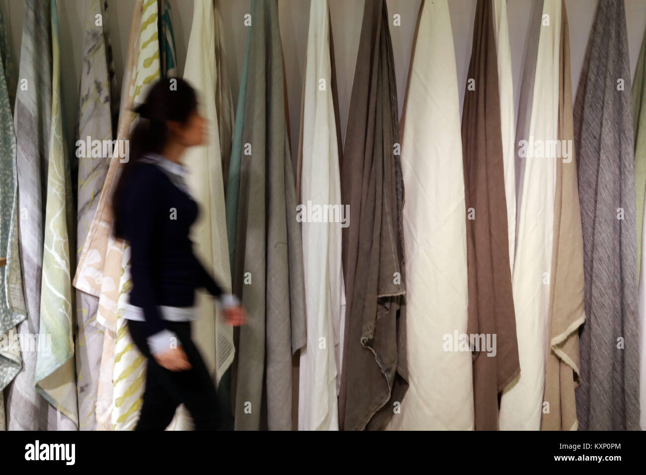 Frankfurt, Germany. 11th Jan, 2018. A woman works at a Chinese textile booth at Heimtextil, the world's largest international trade fair for home and contract textiles, in Frankfurt, Germany, on Jan. 11, 2018. A total of 2,975 exhibitors from 64 countries and regions attended the trade fair this year, 545 of which are from China. Credit: Luo Huanhuan/Xinhua/Alamy Live News Stock Photo