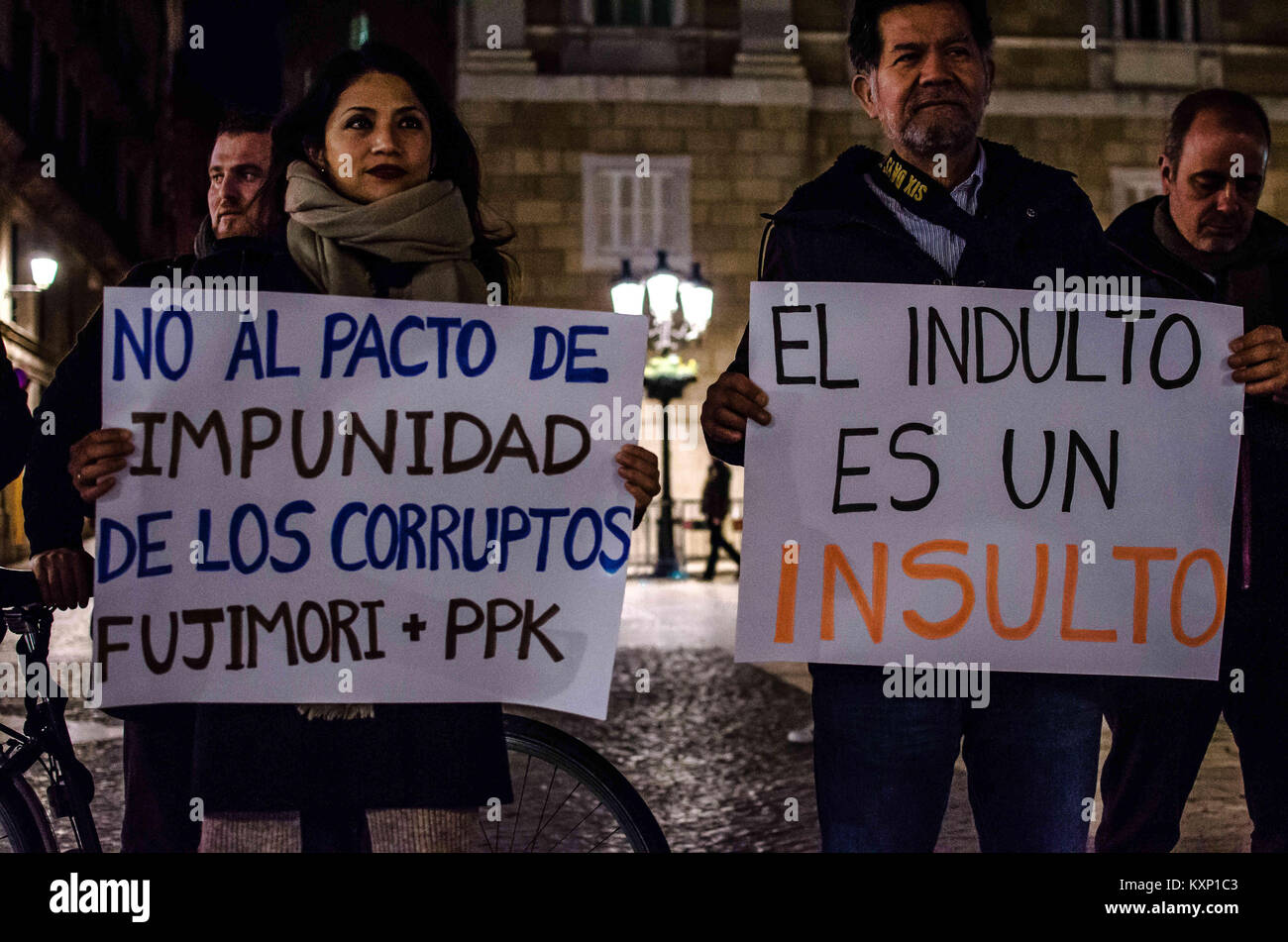 Barcelona, Catalonia, Spain. 11th Jan, 2018. Two demonstrators displayed posters against Fujimori. A group of resident Peruvians in Barcelona have gathered to protest on Barcelona's Sant Jaume square to show their rejection of the early release of Alberto Fujimori. This is the second protest against the pardon granted by the current President of the PerÃº Pedro Pablo Kucznski to the former President Alberto Fujimori. Credit: Paco Freire/SOPA/ZUMA Wire/Alamy Live News Stock Photo