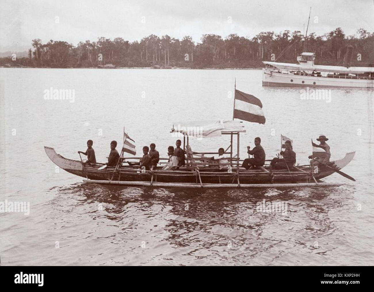 A photograph capturing children paddling a proa, a traditional boat, with Protestant missionary Van Hasselt. The image showcases cross-cultural interactions during missionary work. Stock Photo