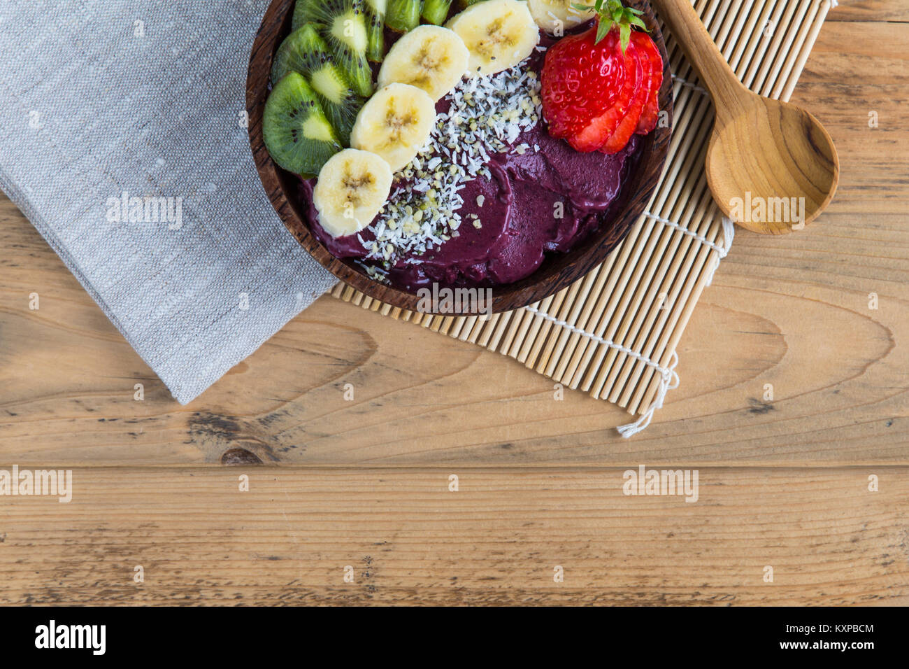 Acai bowl with spoon and napkin Bowl of acai purée with toppings of