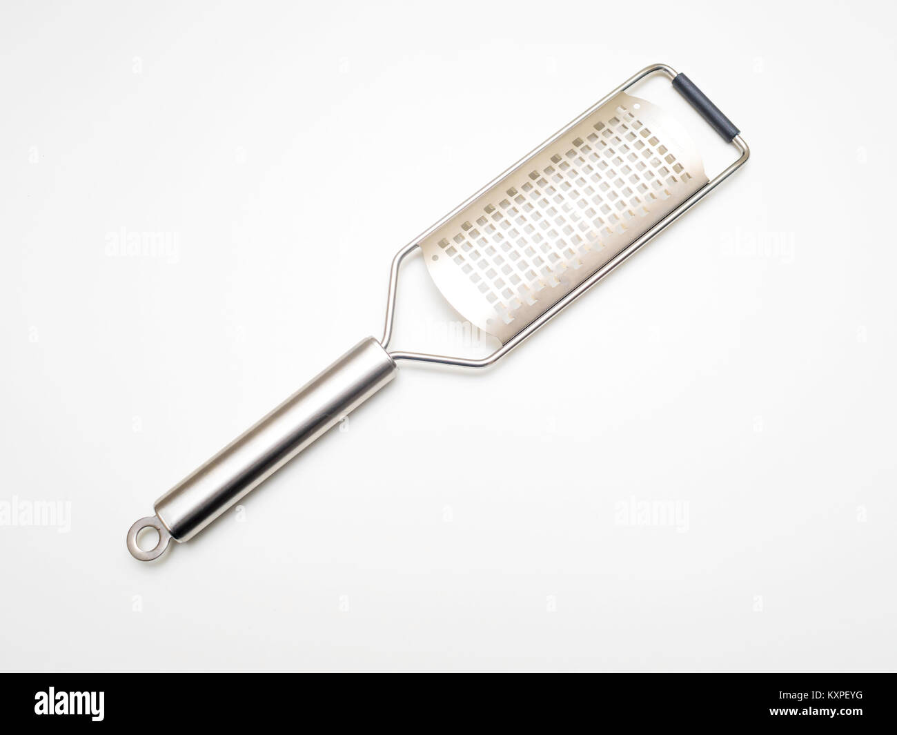 A stainless steel hand held micro grater for dressing a dish with cheese, chocolate or nuts typically used for adding hard cheese to pasta Stock Photo