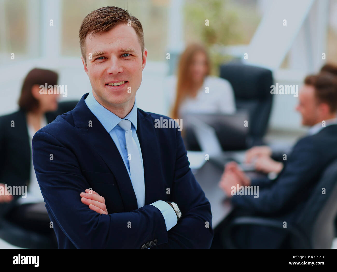 Portrait of an handsome businessman in front of his team Stock Photo ...