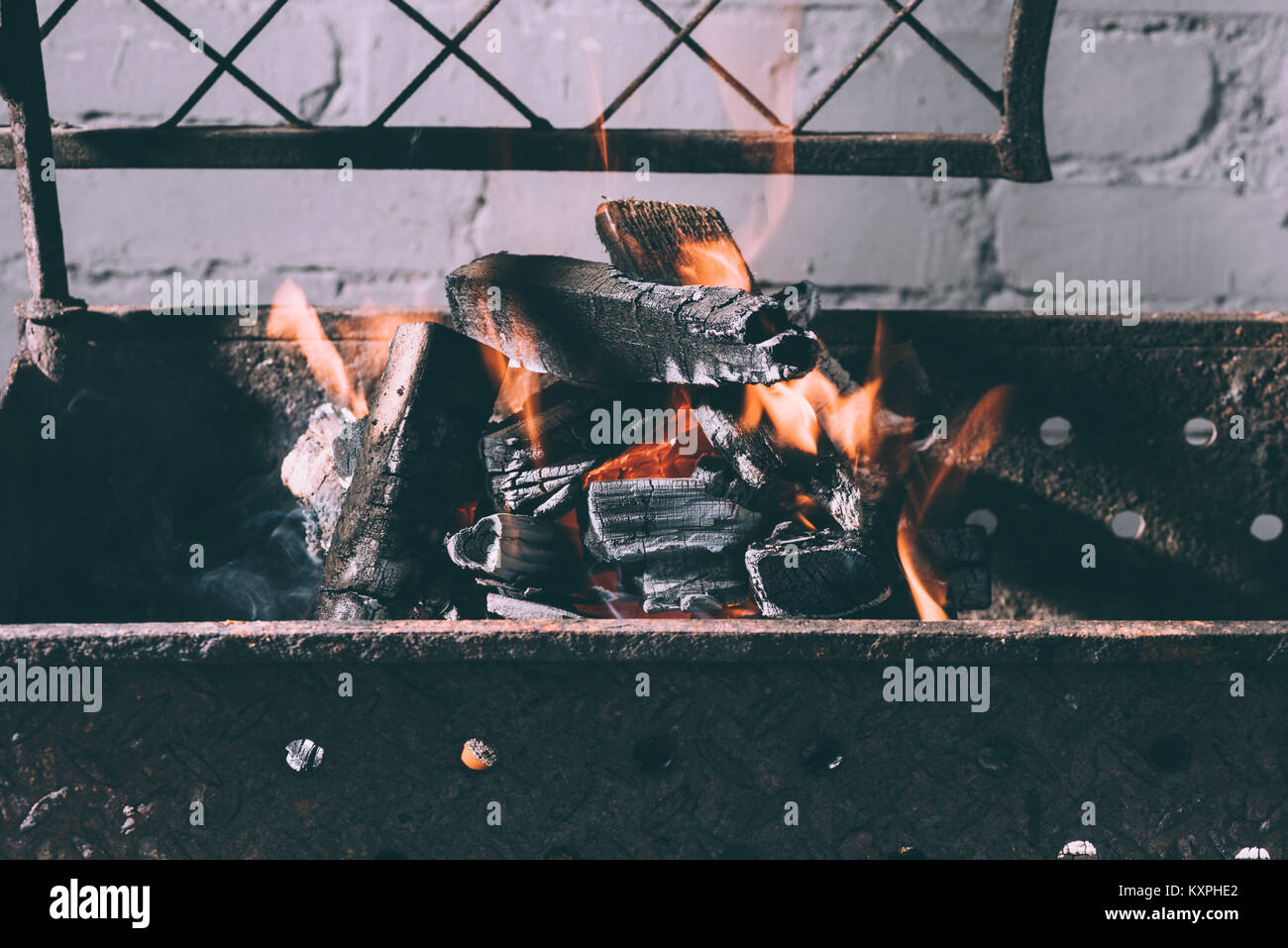 closeup view of grill with fire, flames and charcoals indoors Stock
