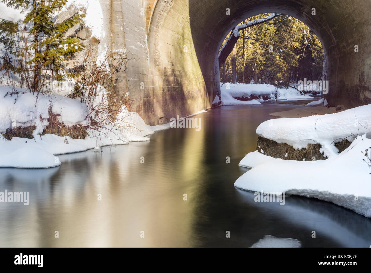 Snow And Ice Covered Creek In Winter Stock Photo - Alamy