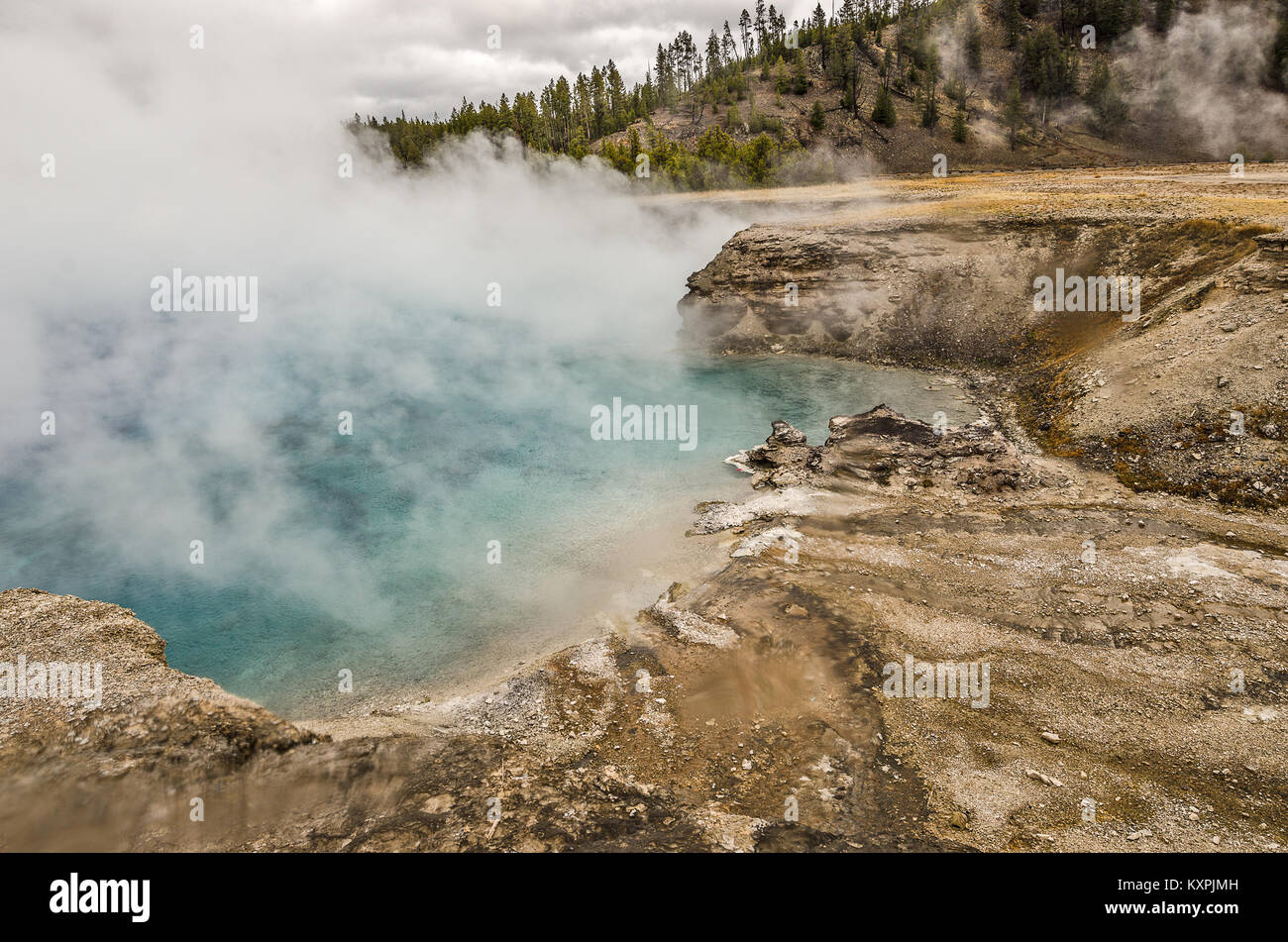 Closeup of Excelsior Geyser in Yellowstone National Park as the wind shifts and blows some of
