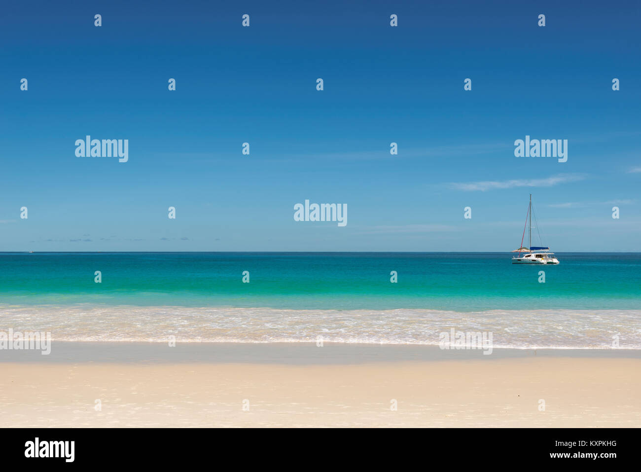 Tropical beach background with sailboat on horizon Stock Photo - Alamy
