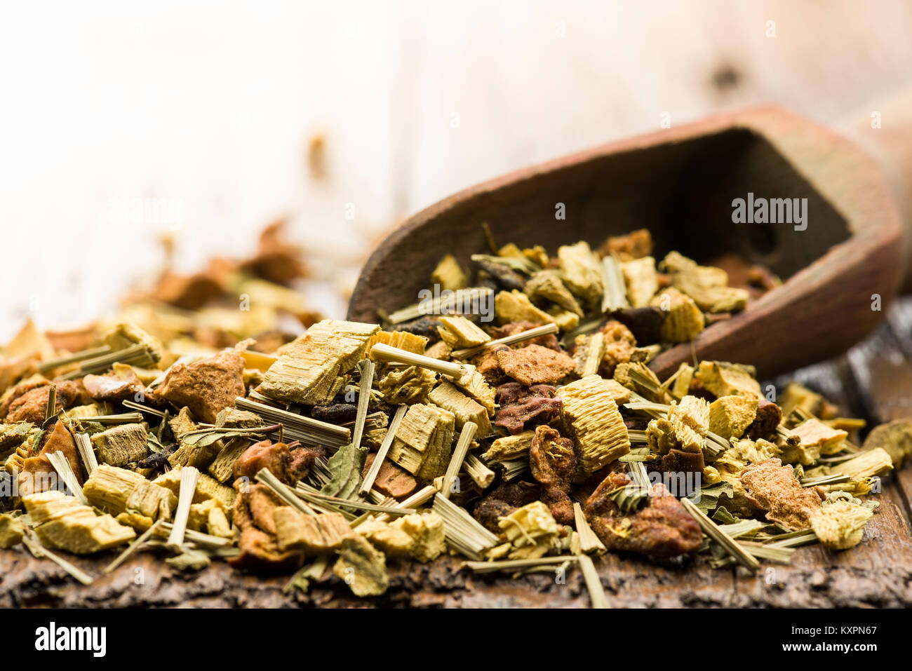 wooden scoop with mixture for digestive tea infusion on table Stock Photo