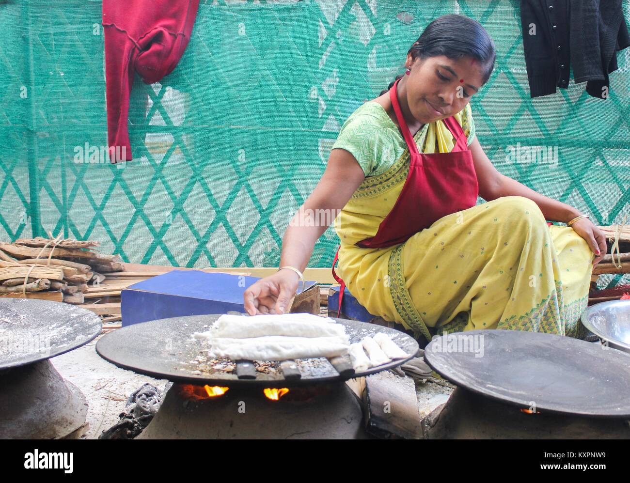 Assamese women preparingTraditional Assamese cake ( Bora Pitha) ahead