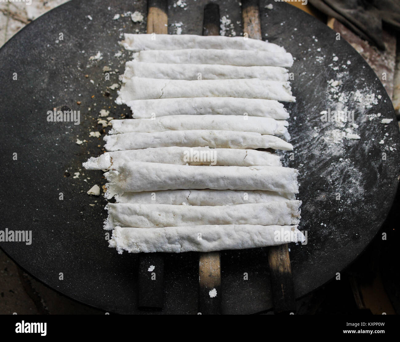 Assamese women preparingTraditional Assamese cake ( Bora Pitha) ahead