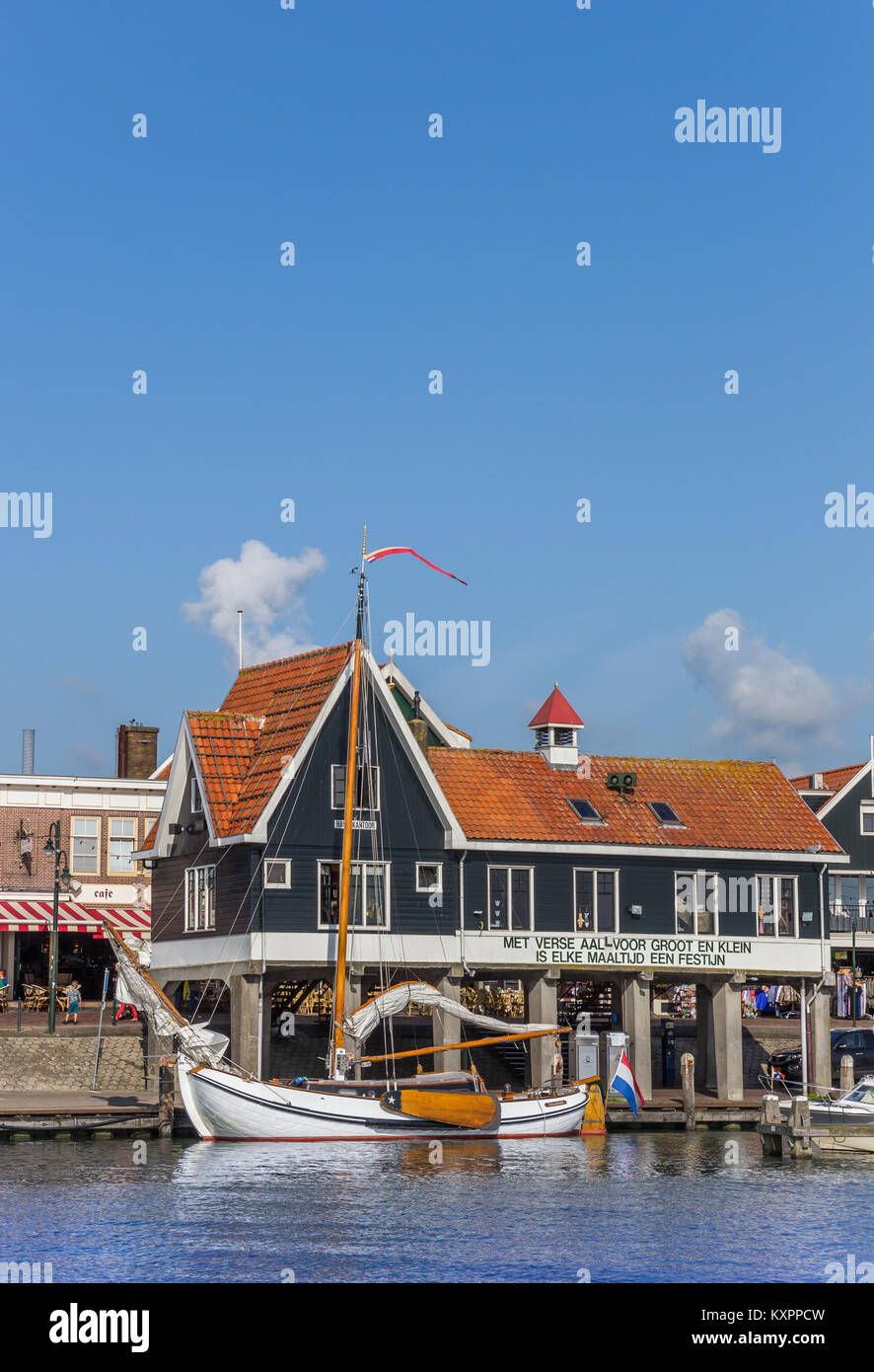 White wooden sailboat in the harbor of Volendam, Holland Stock Photo