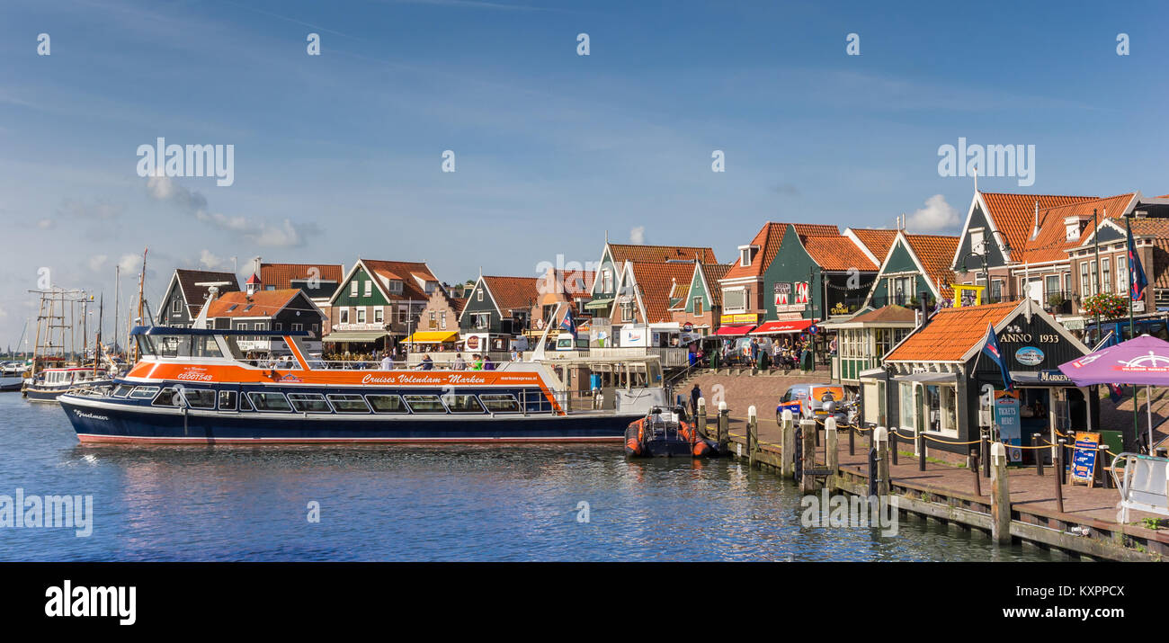 Tour boat in the historic harbor of Volendam, Netherlands Stock Photo