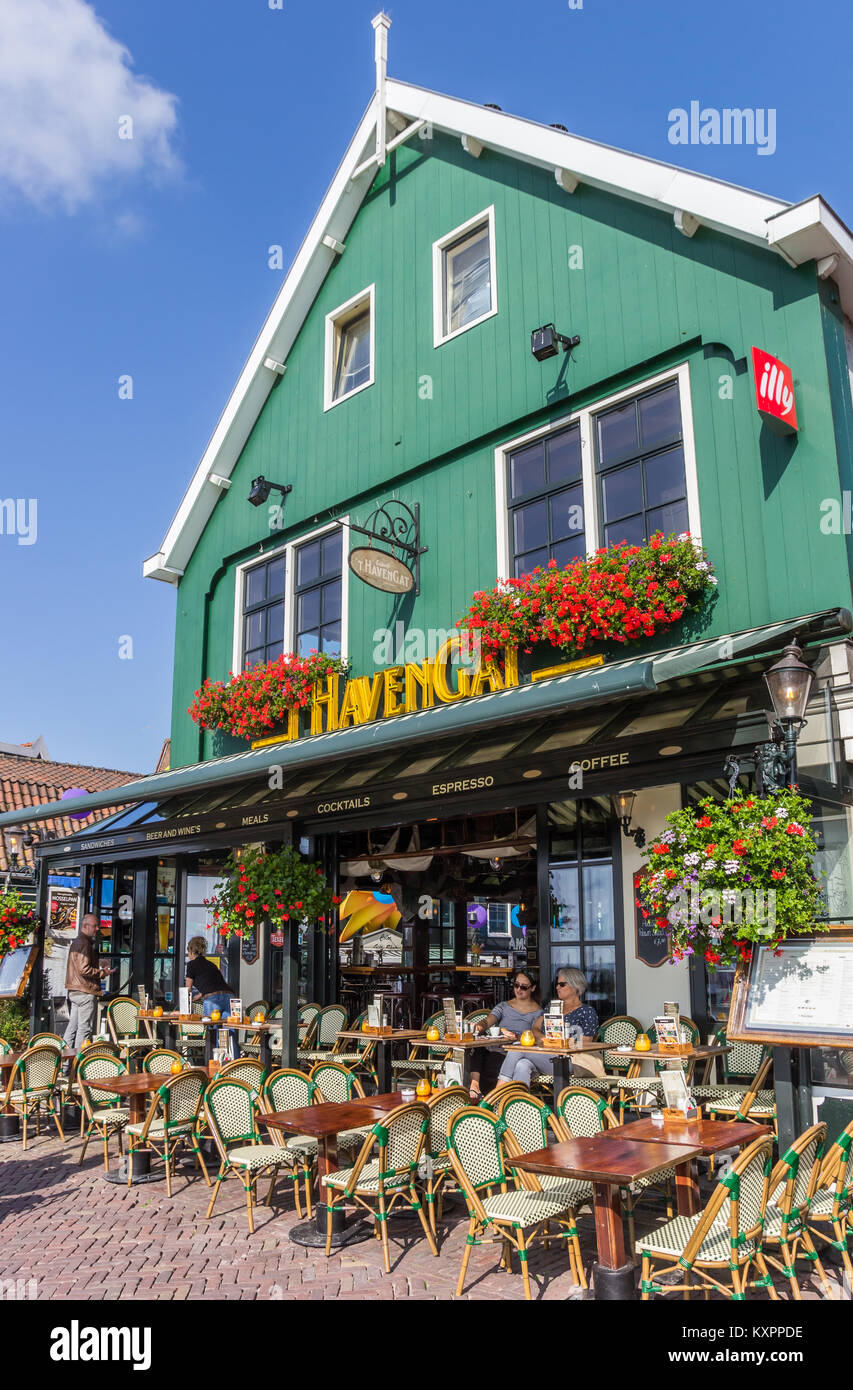 People sitting and drinking at a cafe in Volendam, Netherlands Stock Photo