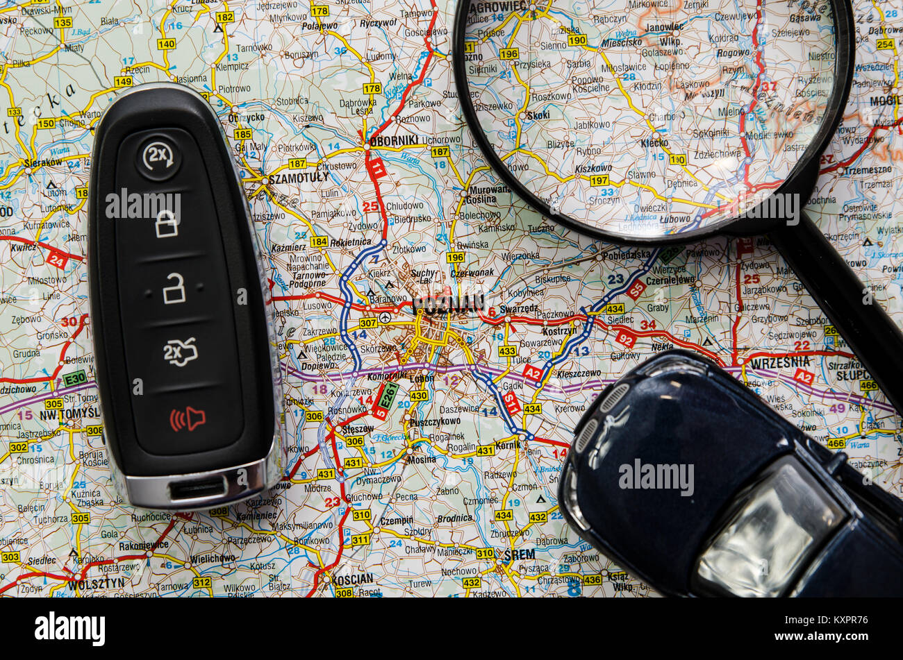 Set of car keys and magnify over a map. Travel concept Stock Photo