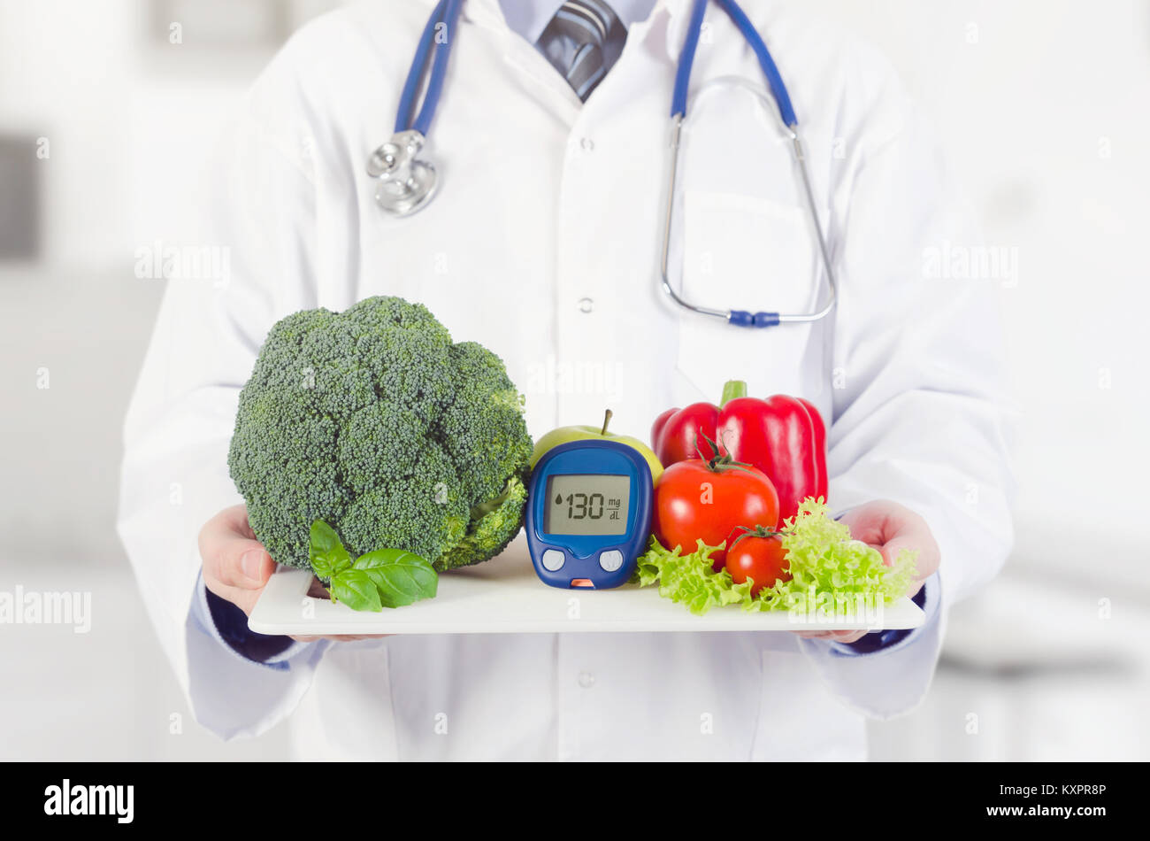 Doctor holding vegetables and fruits on a tray. Diet, nutrition, health care for diabetes concept Stock Photo